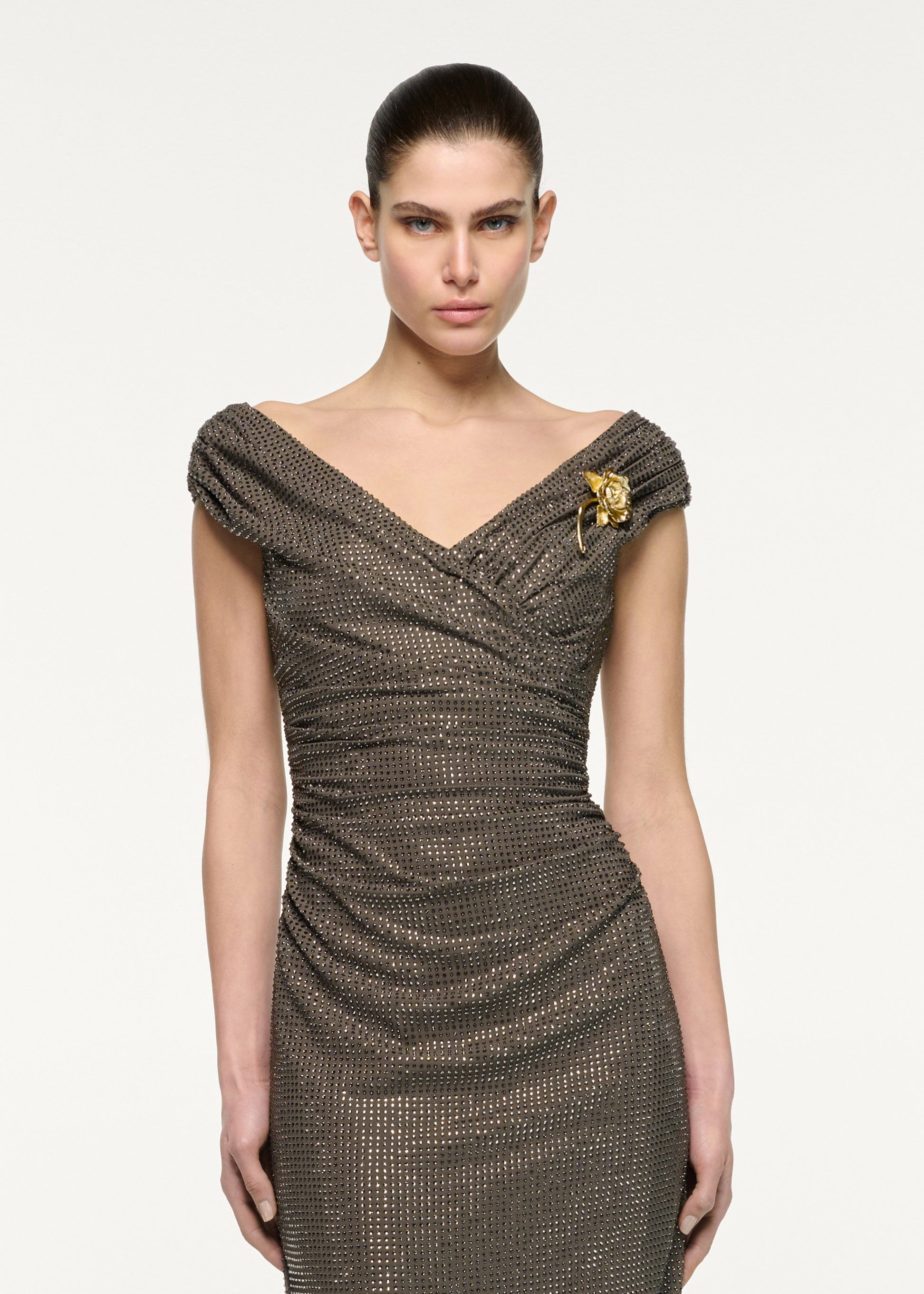 Close up of a model wearing the Gold Rose Brooched Diamante Midi Dress in Taupe