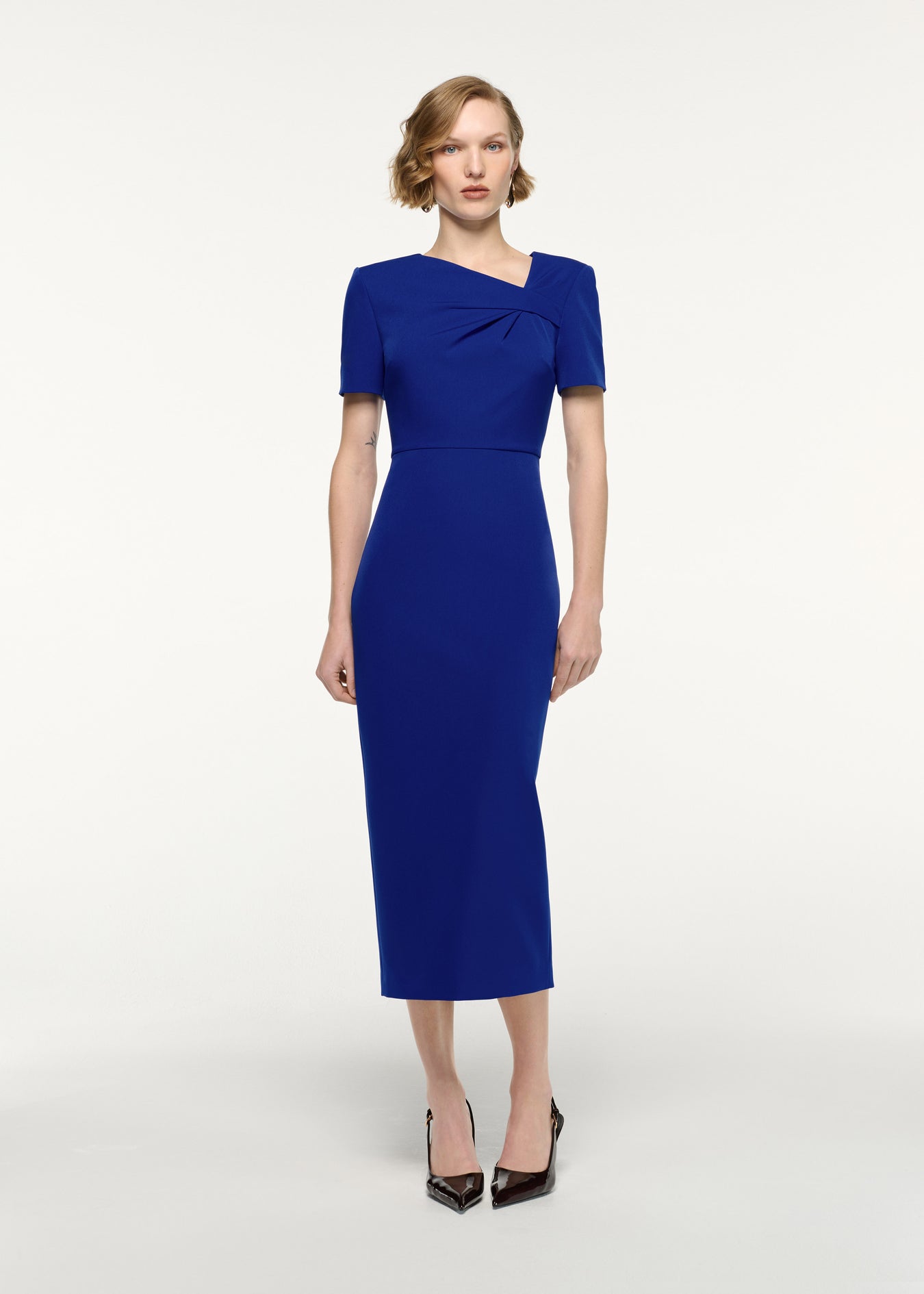 Front view of a model wearing the Asymmetric Twist Drape Midi Dress in Blue
