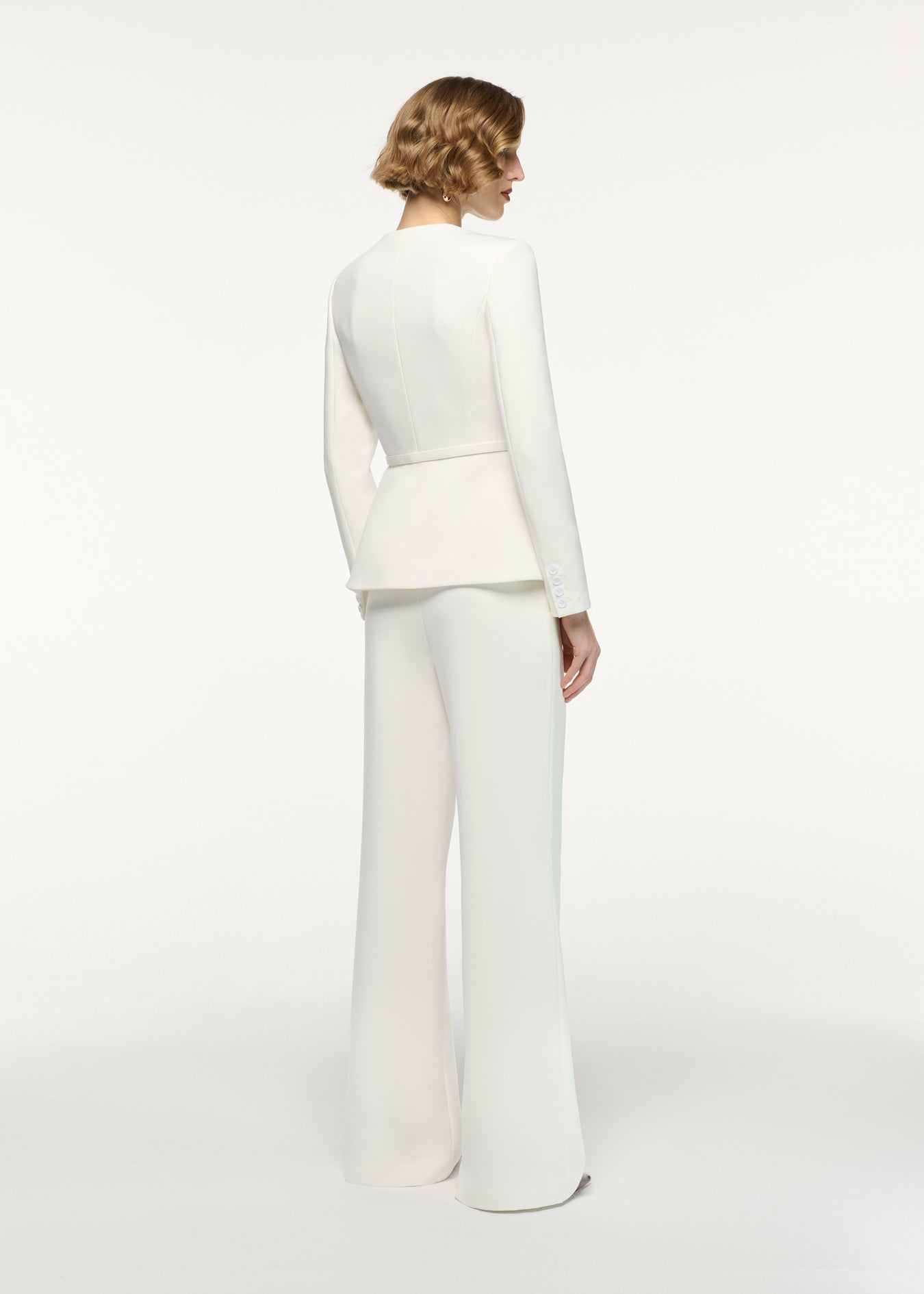 Back view of a model wearing the Straight Leg Crepe Trousers in Cream 