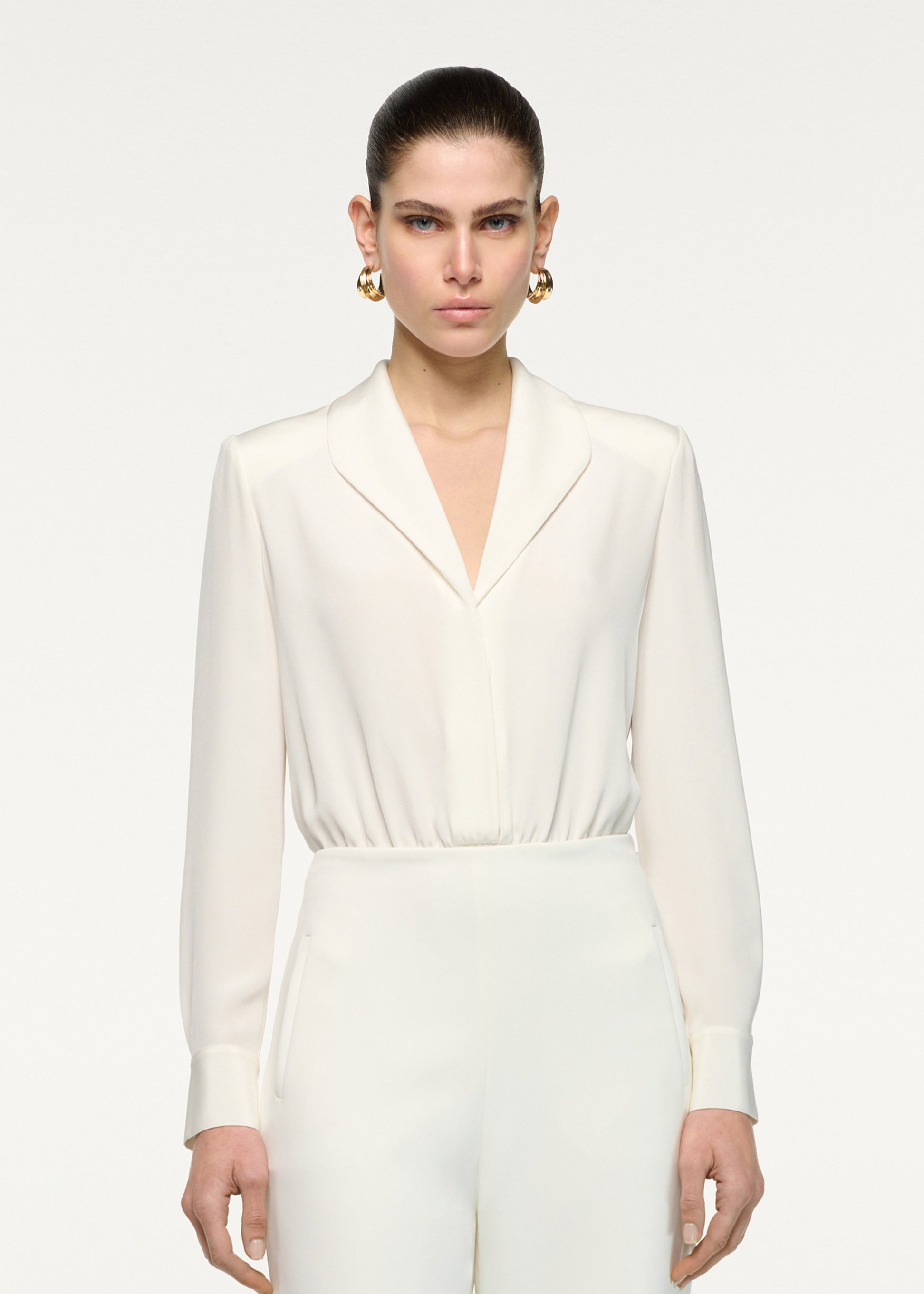 Close up of a model wearing the Silk Shirt Bodysuit in Cream 