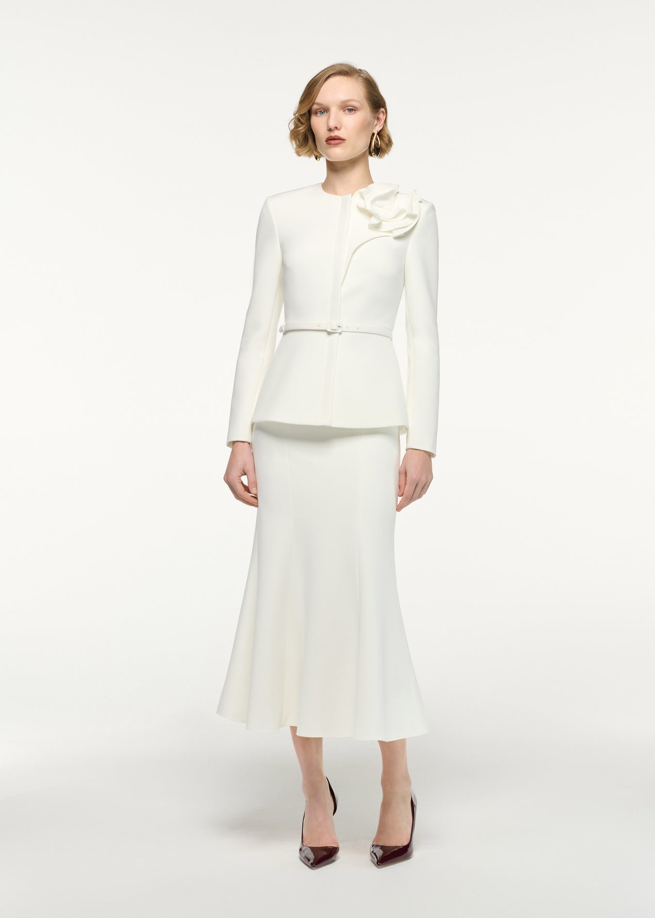 Front view of a model wearing the Fit And Flare Midi Skirt in Cream 