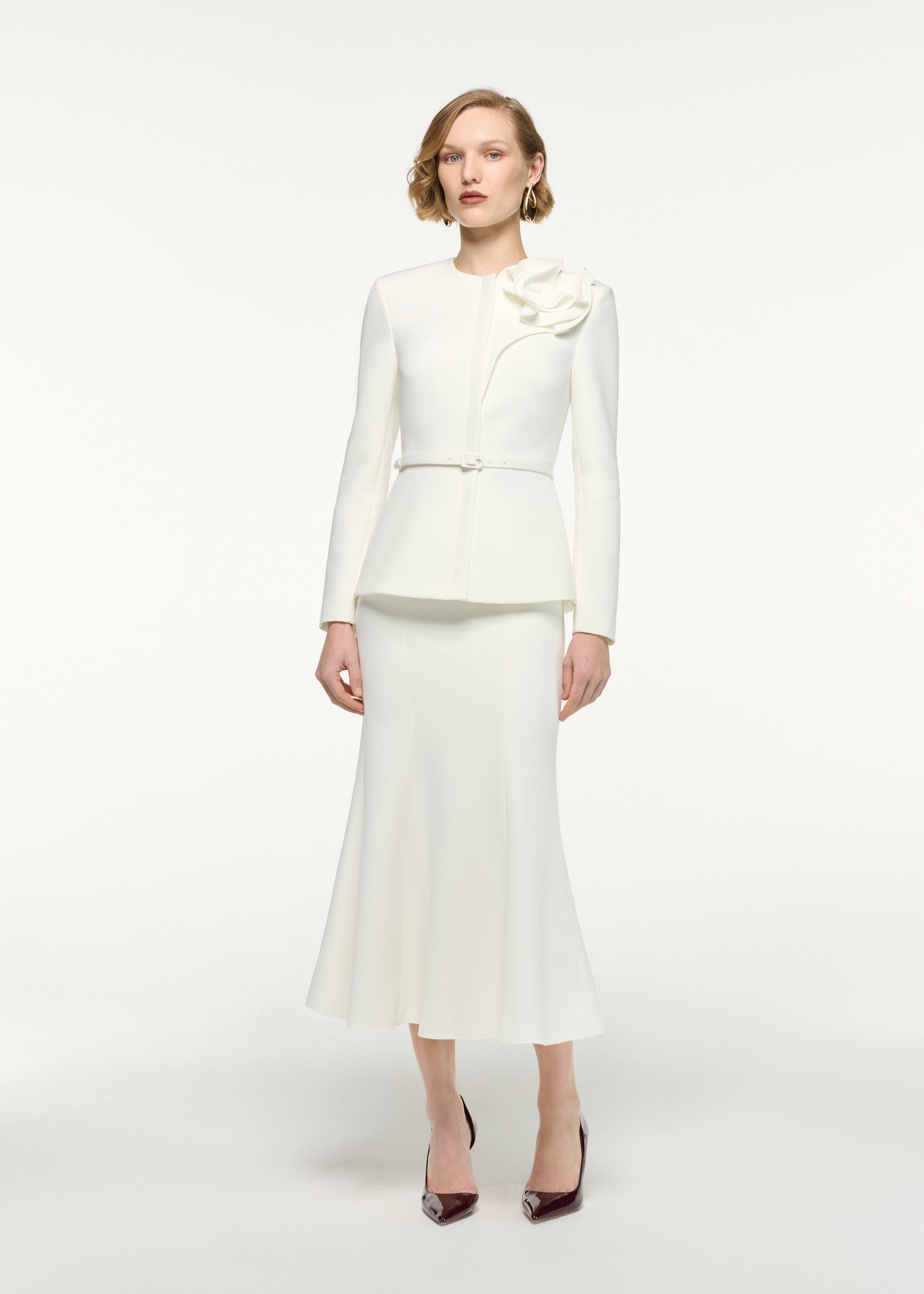 Front view of a model wearing the Fit And Flare Midi Skirt in Cream 