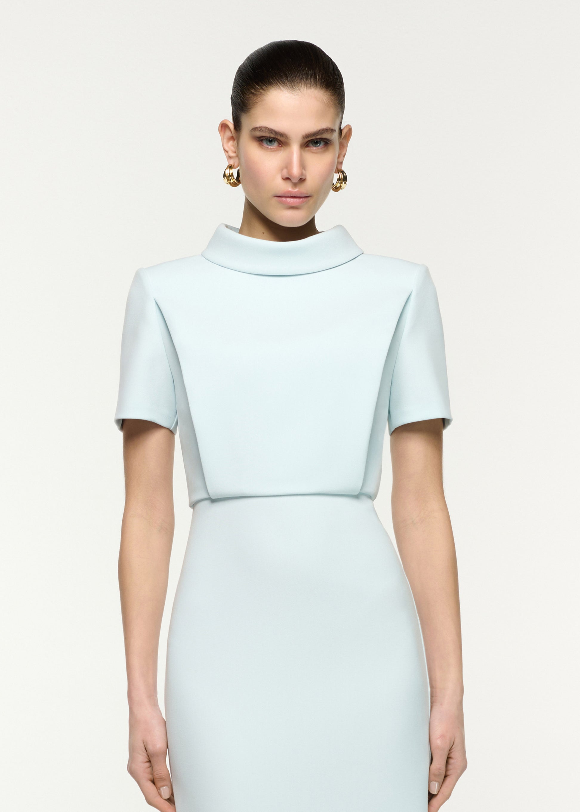 Close up of a model wearing the Collared Crepe Column Midi Dress in Aqua