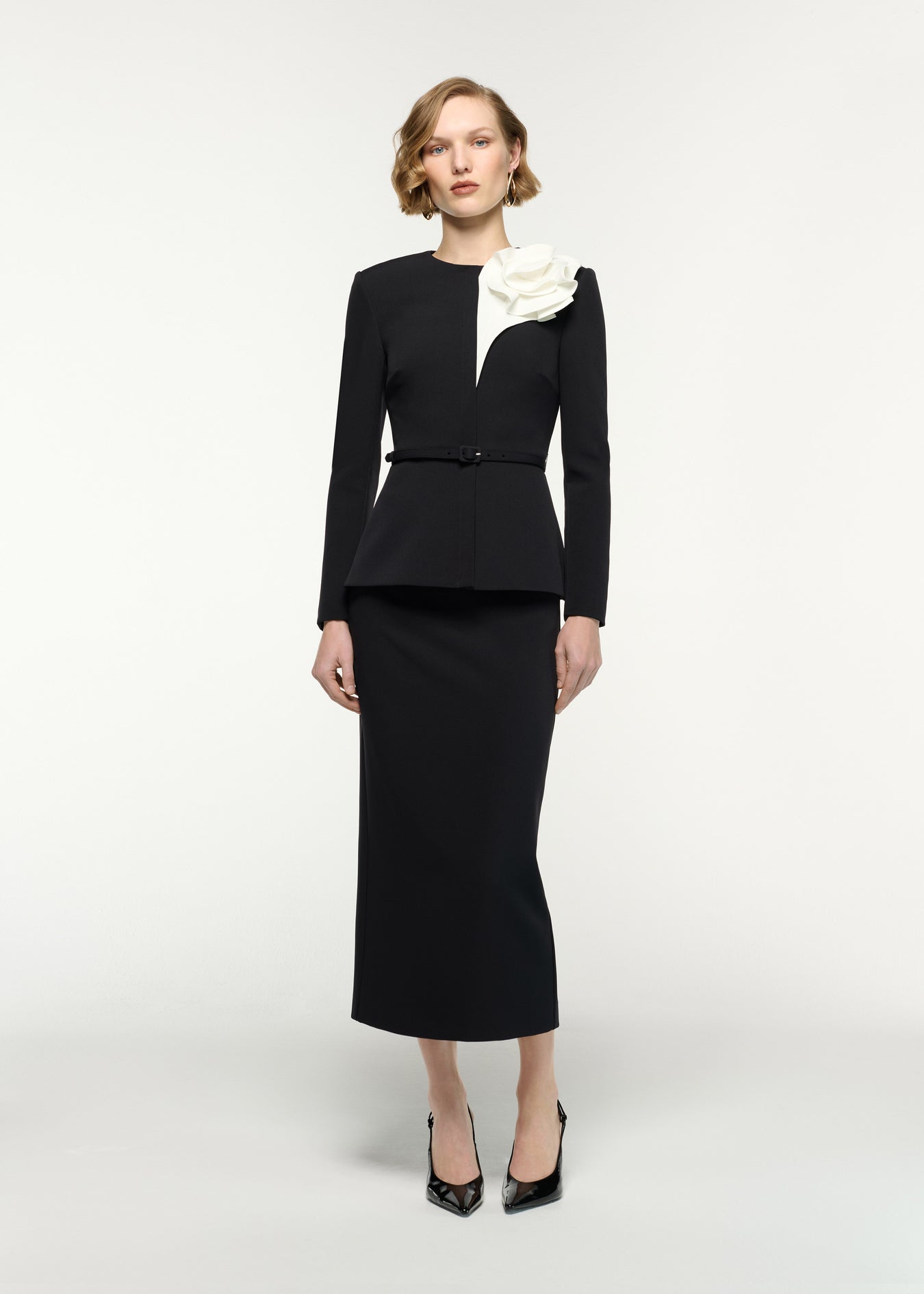 Front view of a model wearing the Column Fit Midi Skirt in Black 