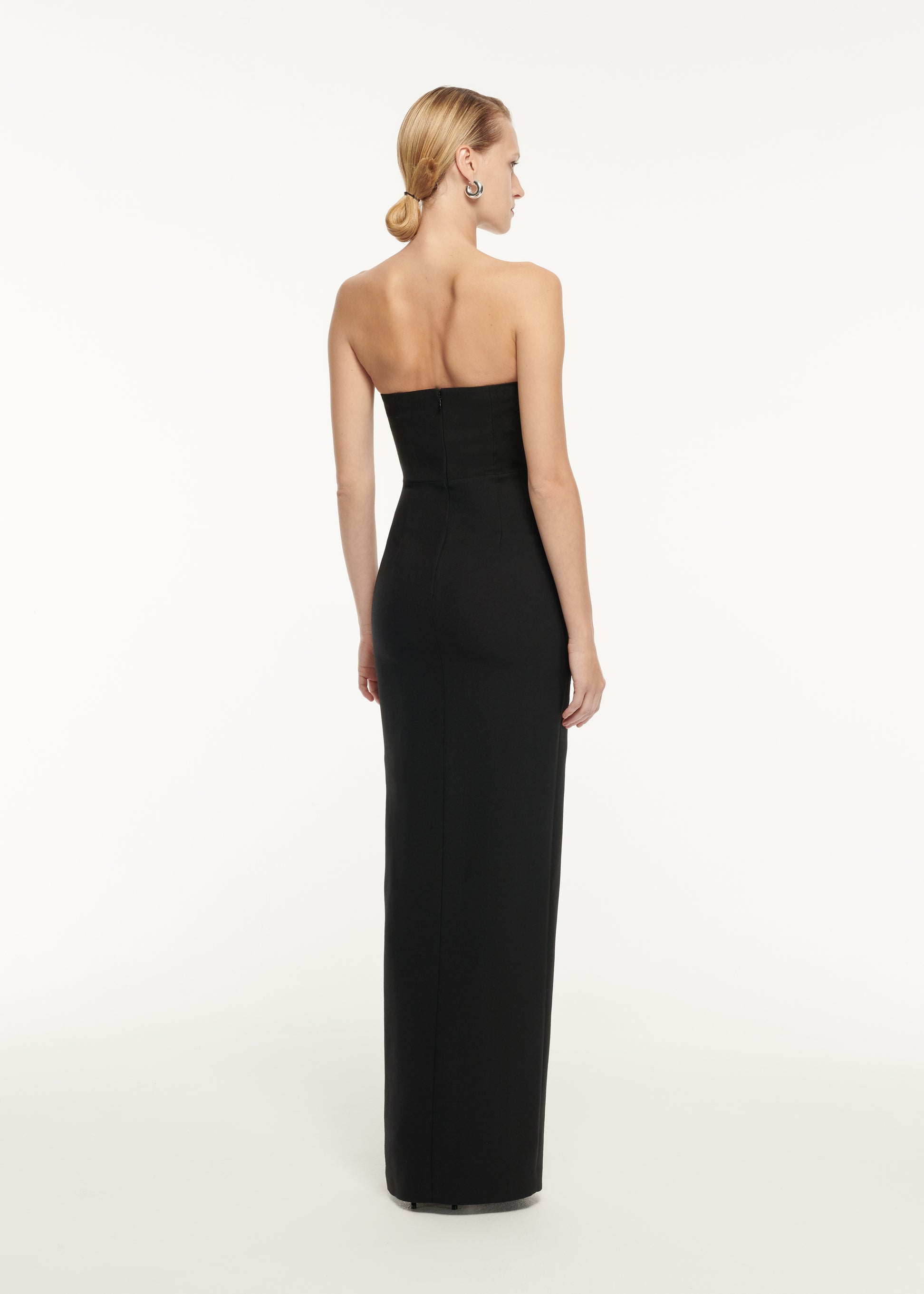 The back of a woman wearing the Strapless Wool Silk Embellished Maxi Dress