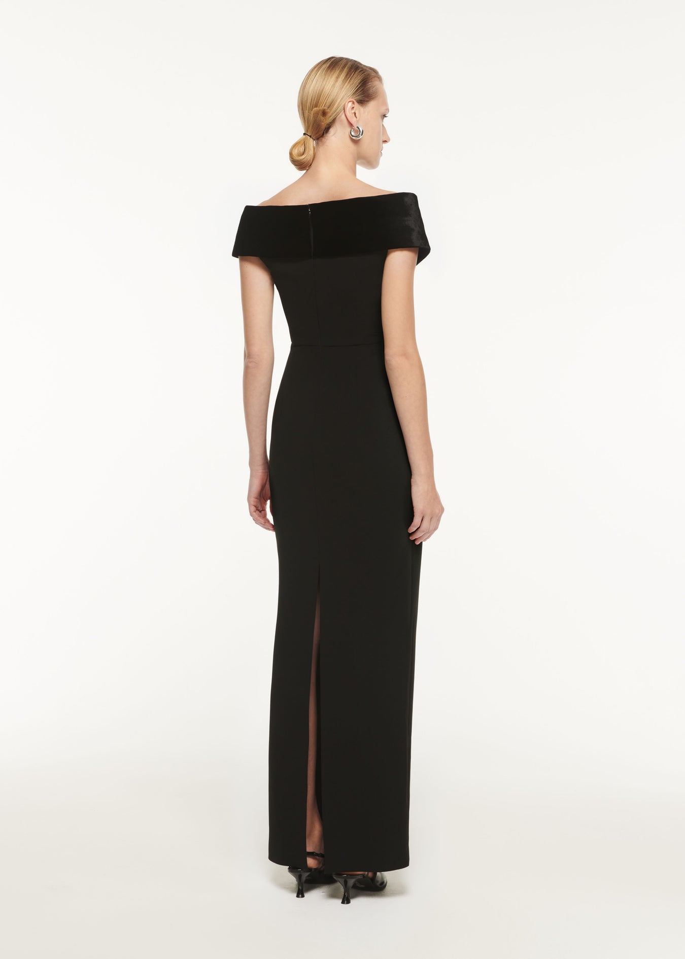 The back of a woman wearing the Off The Shoulder Stretch Cady Maxi Dress Black