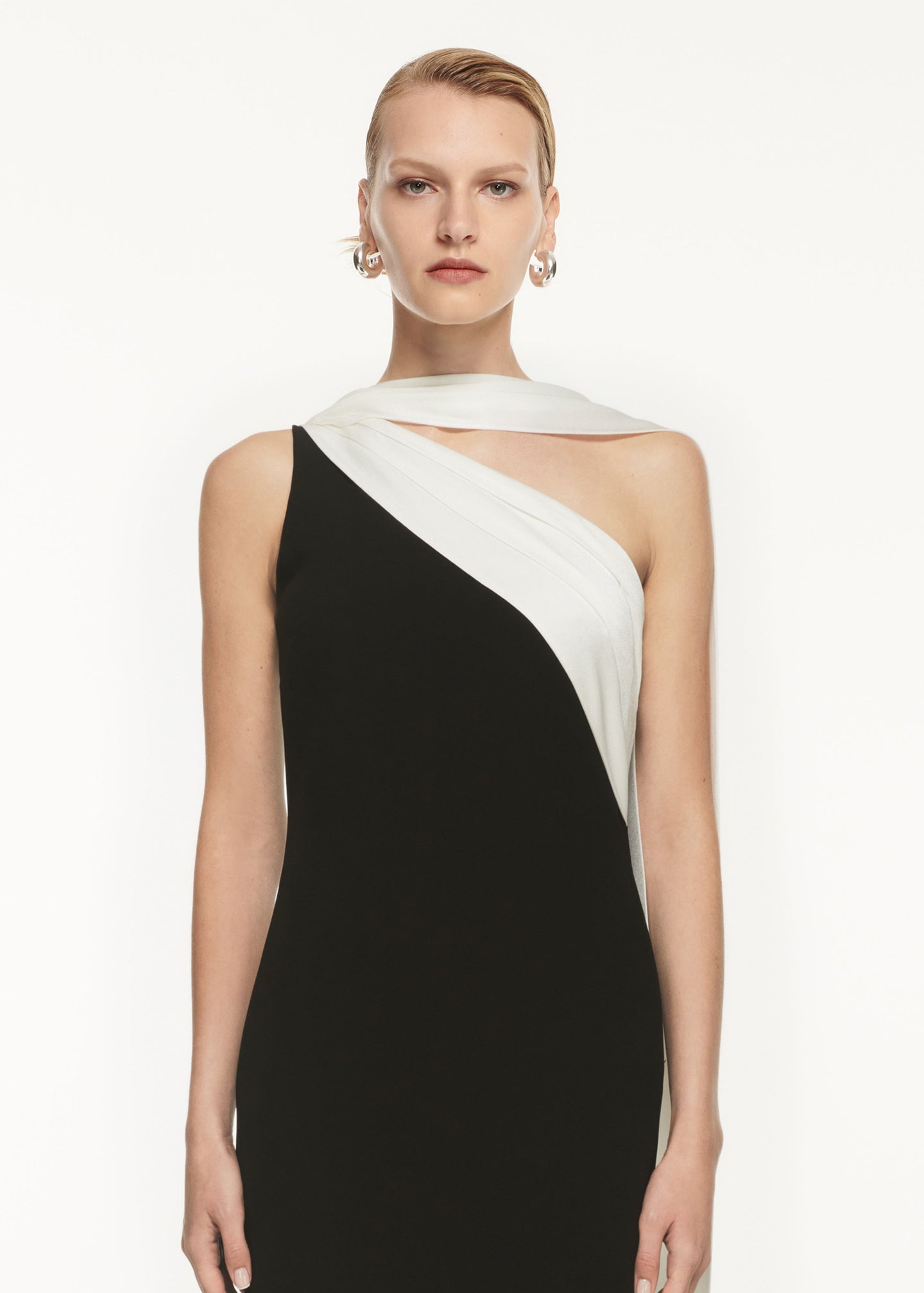 A close up of a woman wearing the Asymmetric Satin Sash Maxi Dress