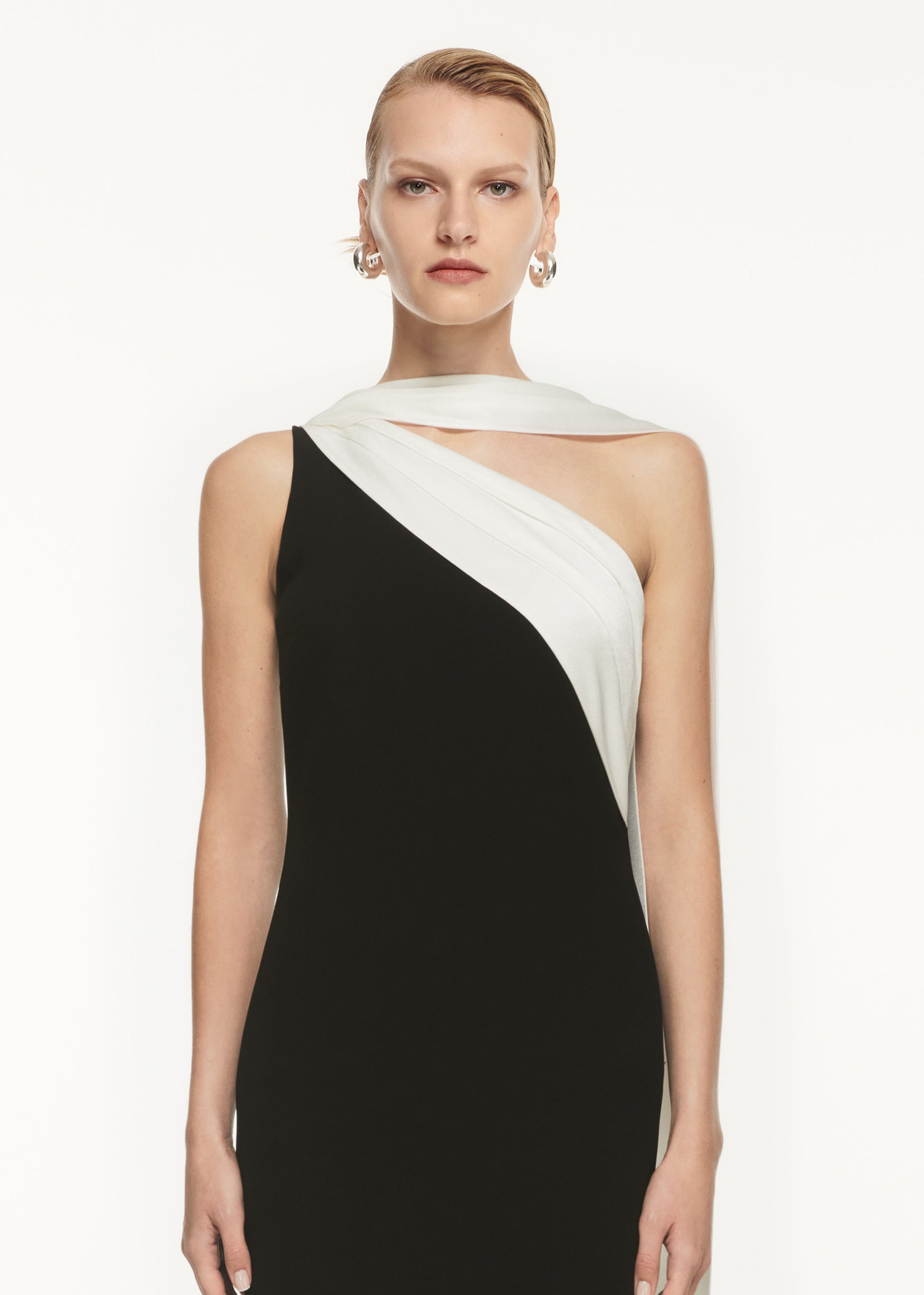 A close up of a woman wearing the Asymmetric Satin Sash Maxi Dress