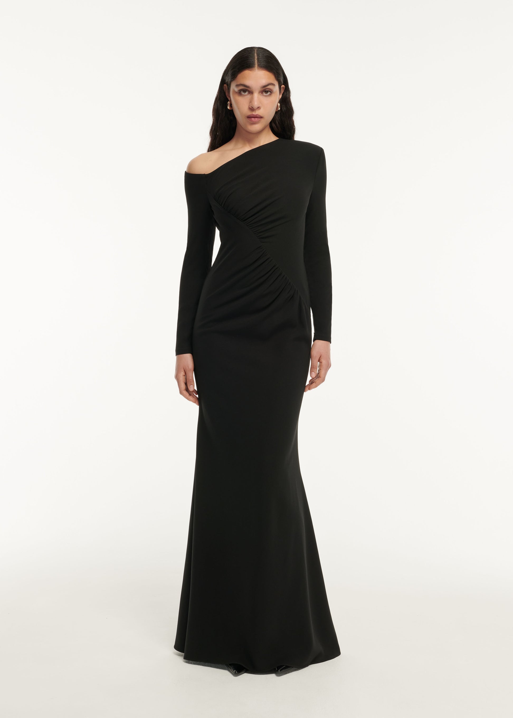 A woman wearing the Long Sleeve Stretch Cady Drape Maxi Dress in Black