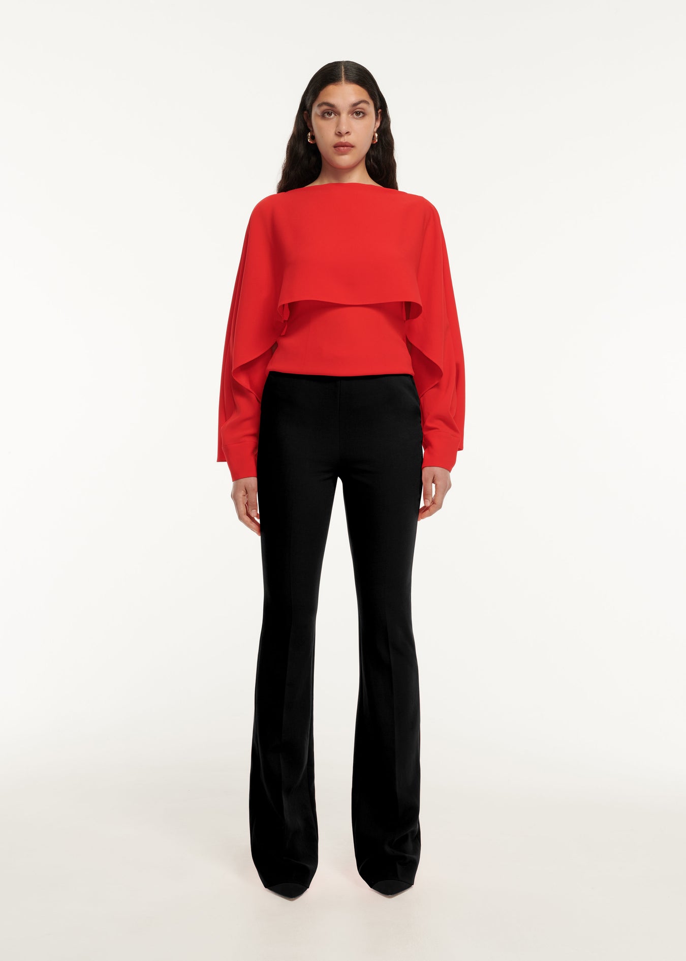 A woman wearing the Long Sleeve Satin Crepe Top in Red