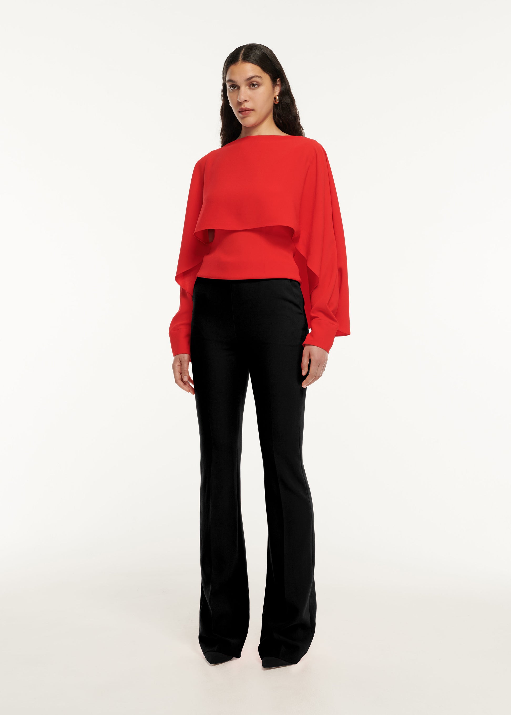 A woman wearing the Long Sleeve Satin Crepe Top in Red