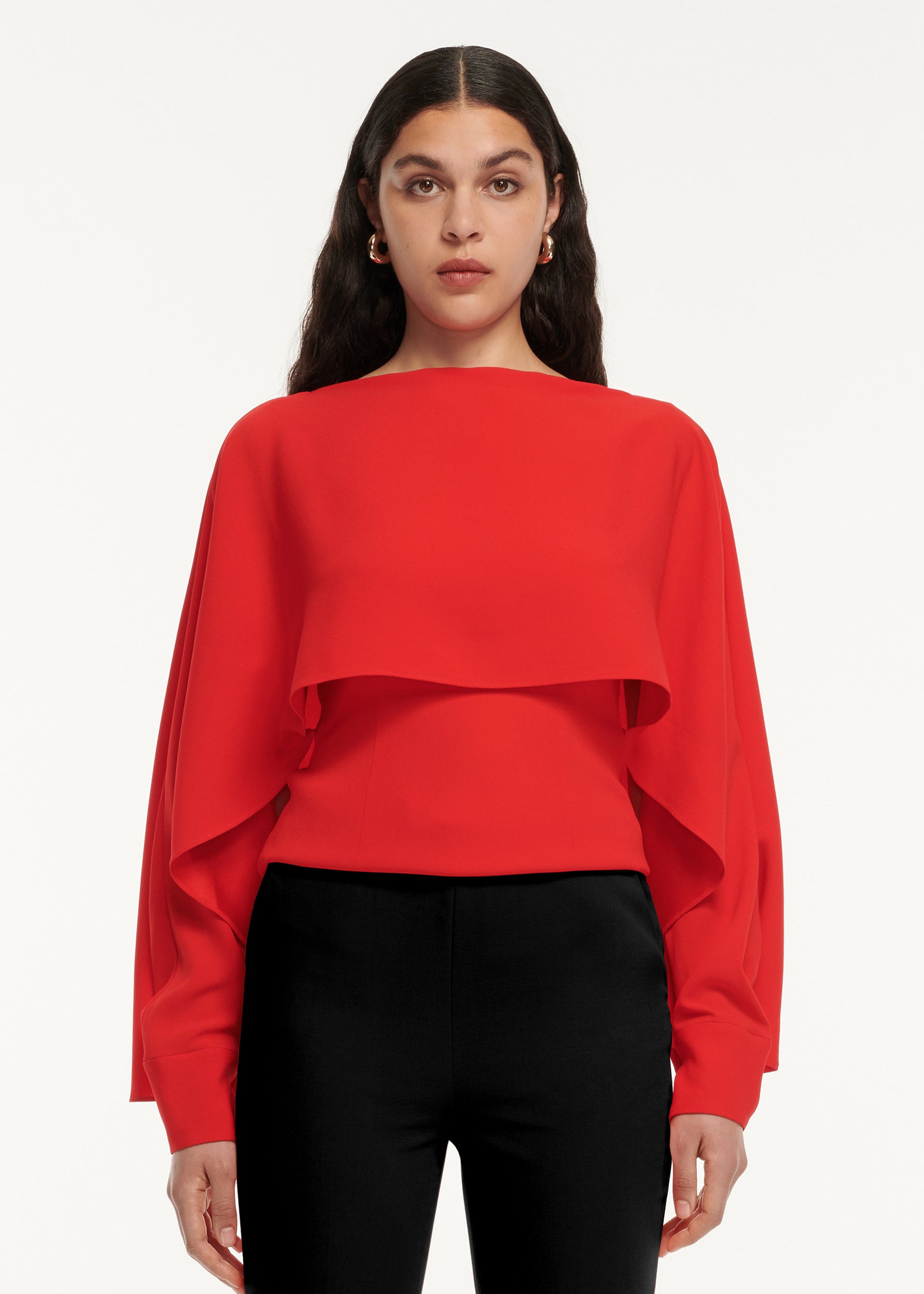 A close up of a woman wearing the Long Sleeve Satin Crepe Top Red