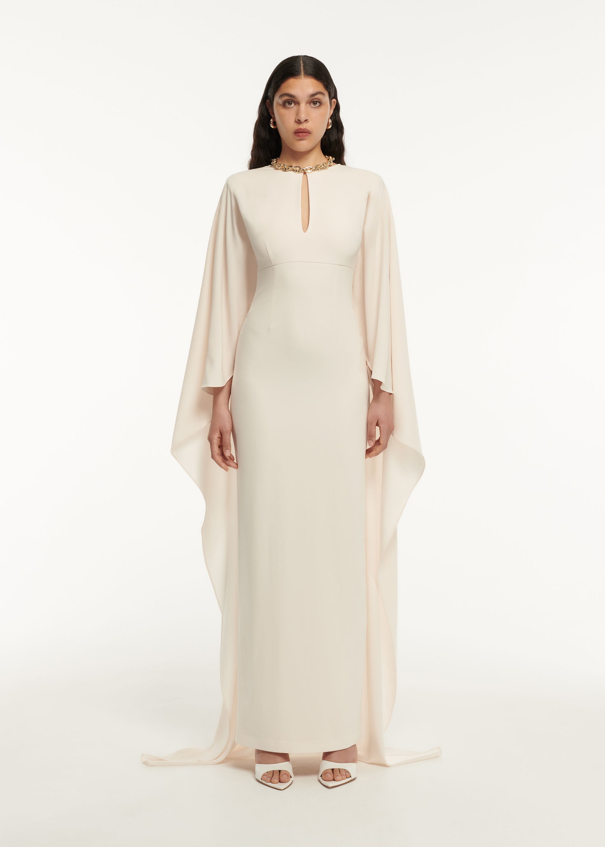 A woman wearing the Long Sleeve Satin Crepe Maxi Dress in Cream