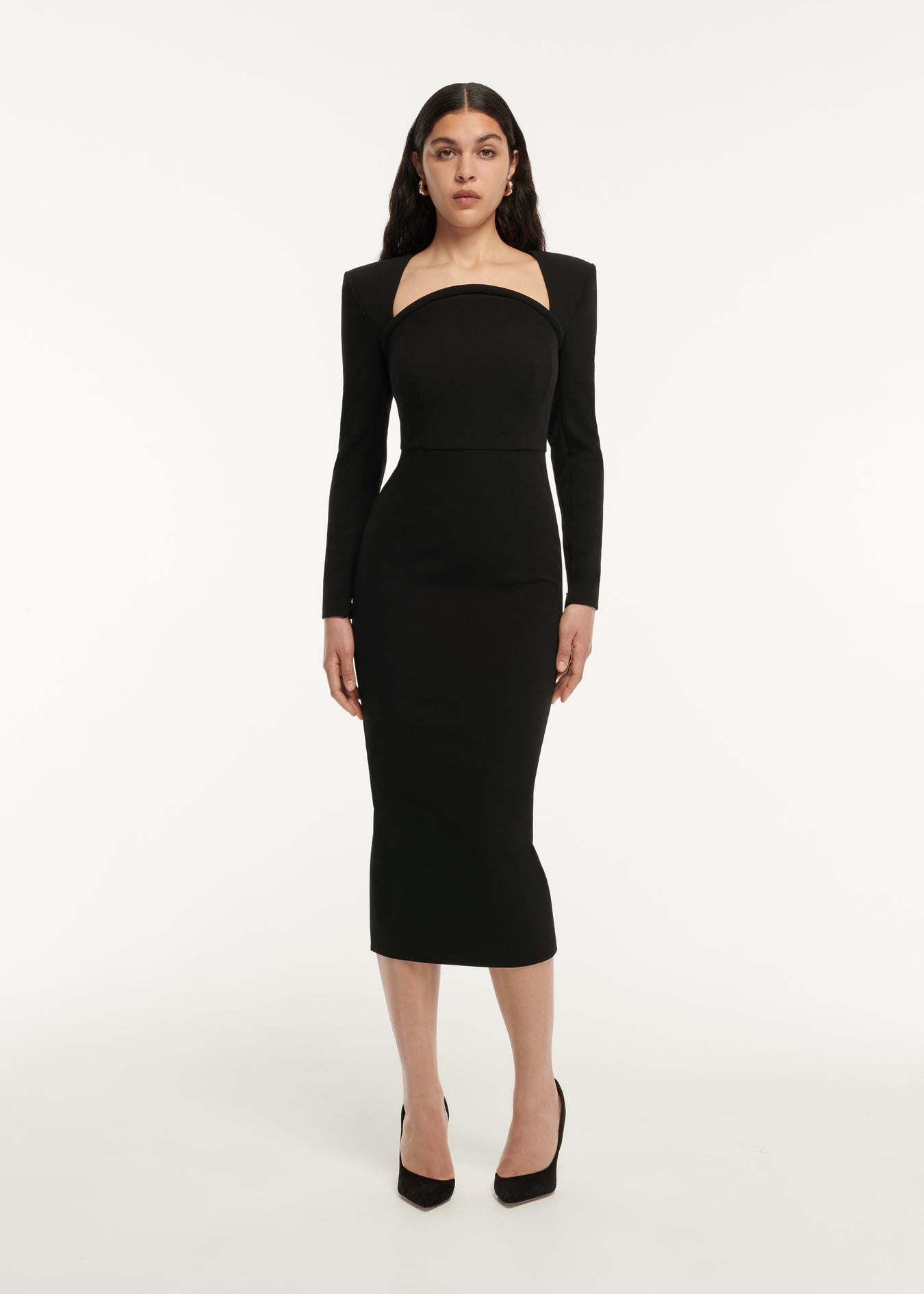 A woman wearing the Long Sleeve Curved Stretch Cady Midi Dress