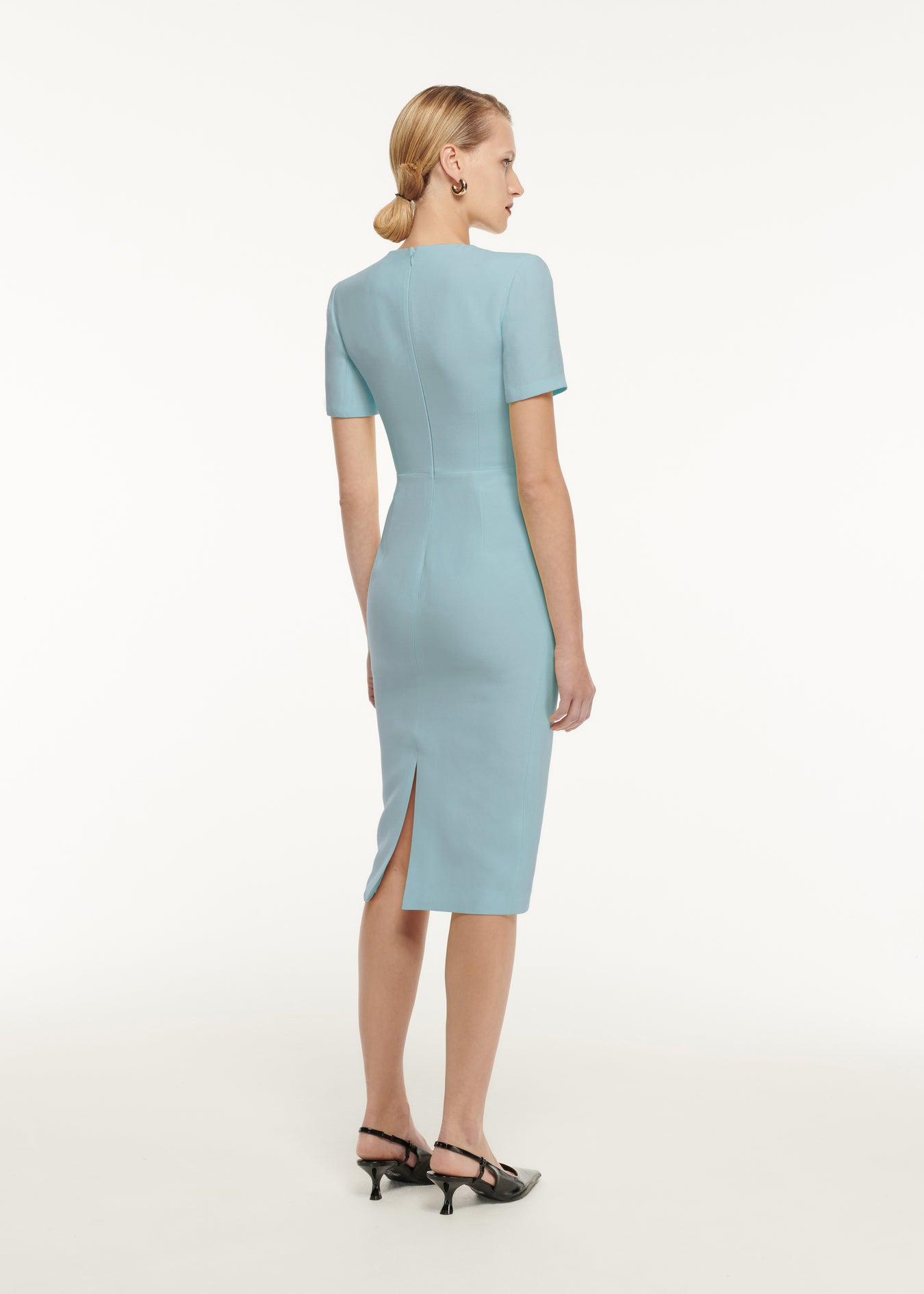 The back of a woman wearing the Short Sleeve Pleat Detail Wool Silk Midi Dress