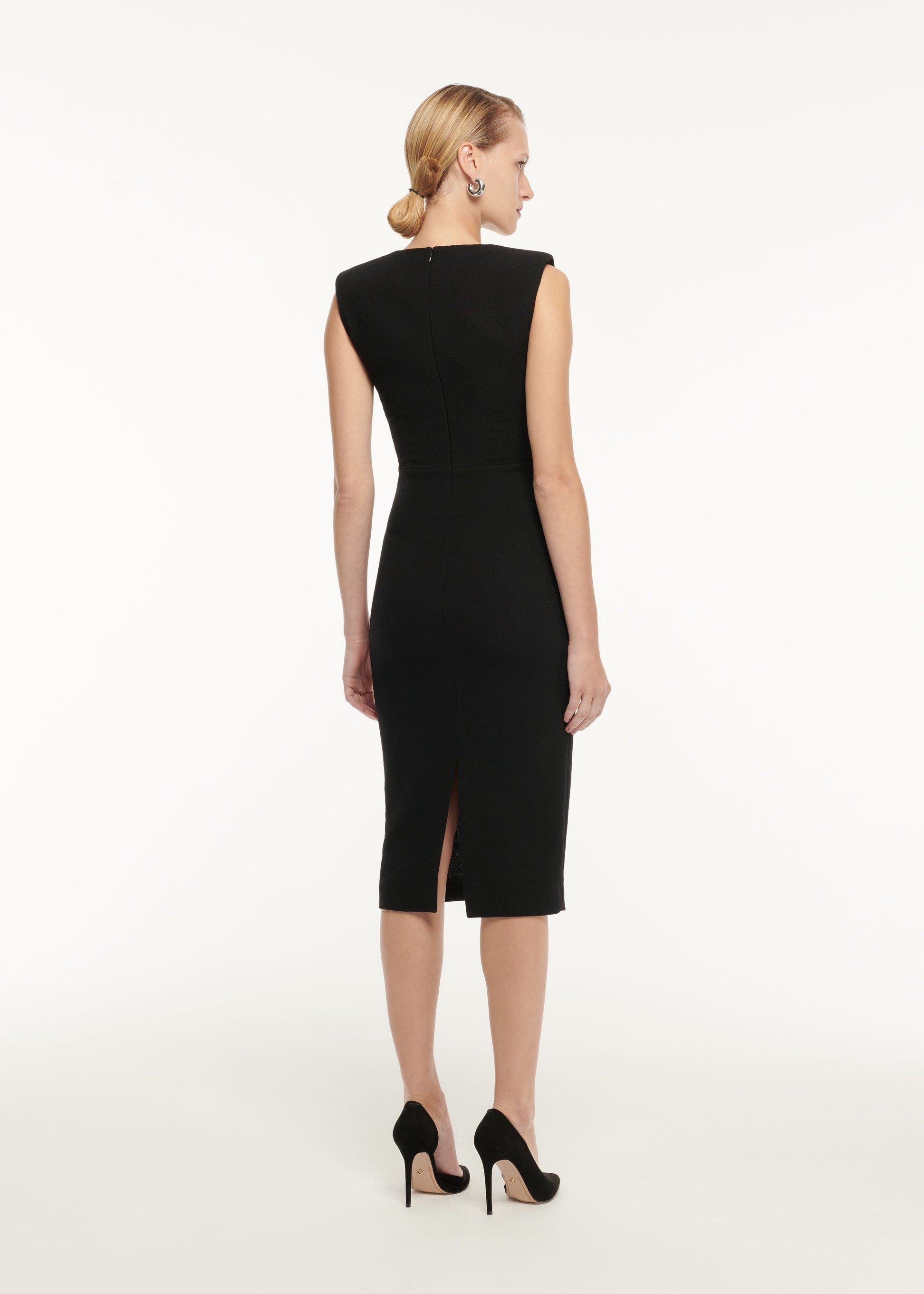 The back of a woman wearing the Asymmetric Panelled Stretch Cady Midi Dress