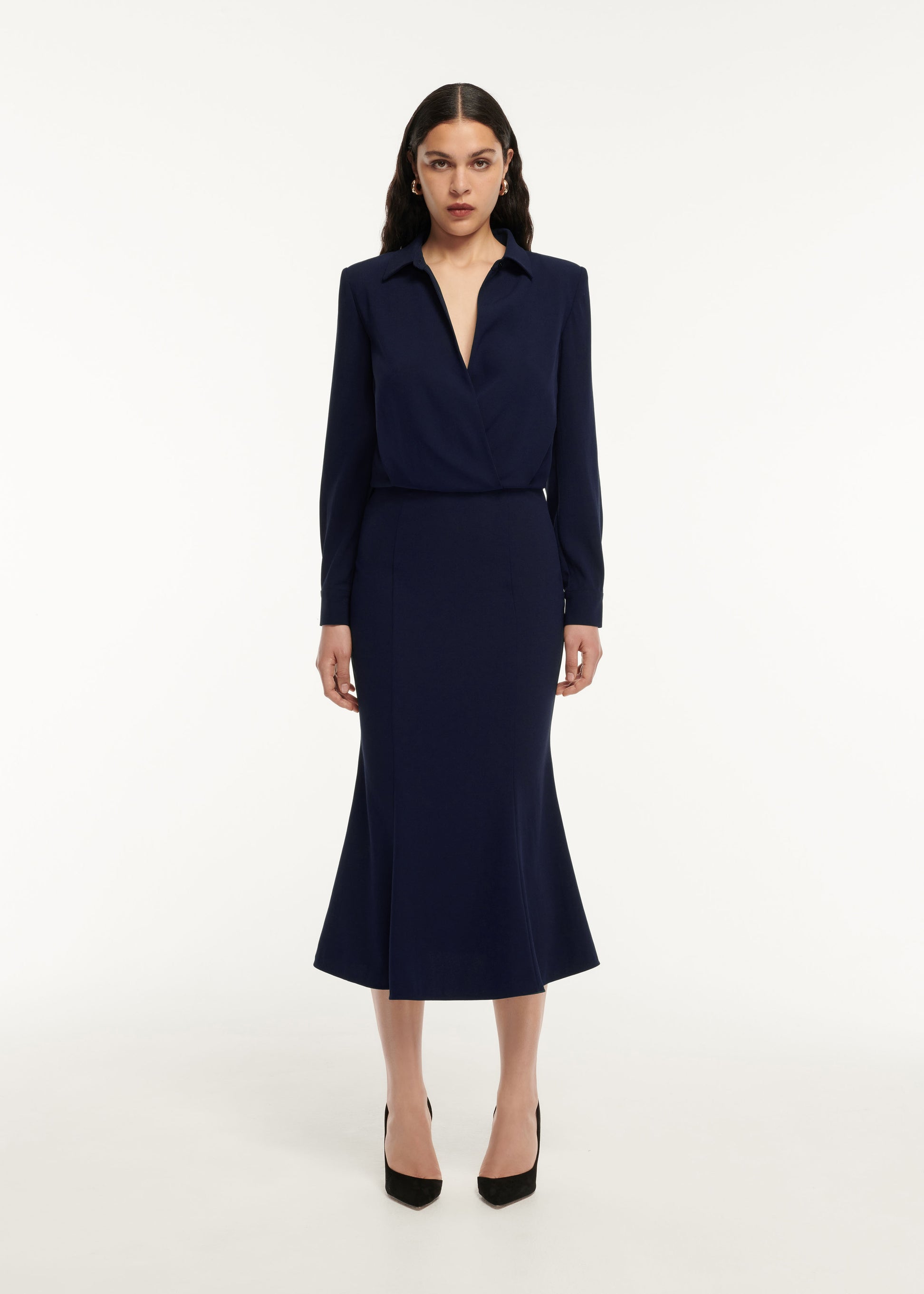 A woman wearing the Long Sleeve Collar Satin Crepe Midi Dress in Navy