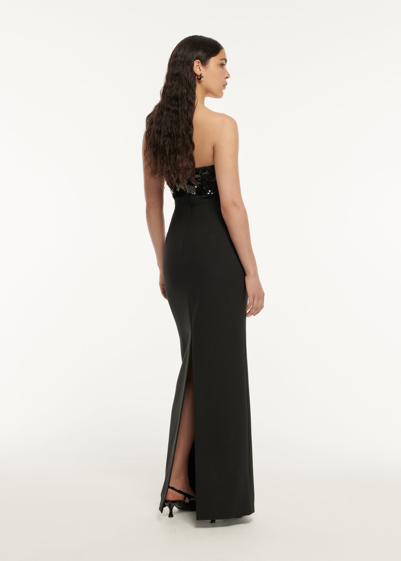 The back of a woman wearing the Strapless Embellished Maxi Dress