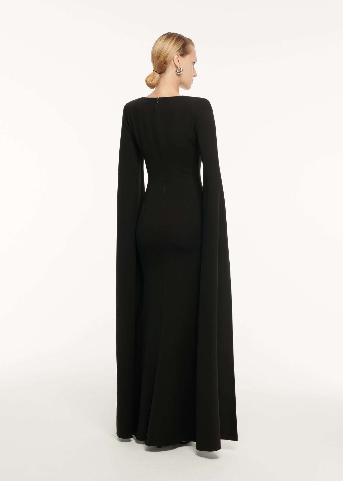 The back of a woman wearing the Asymmetric Diamante Maxi Dress