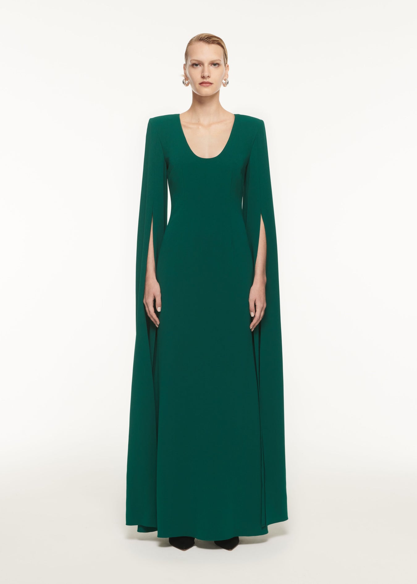 A woman wearing the Cape Sleeve Stretch Cady Maxi Dress in Green
