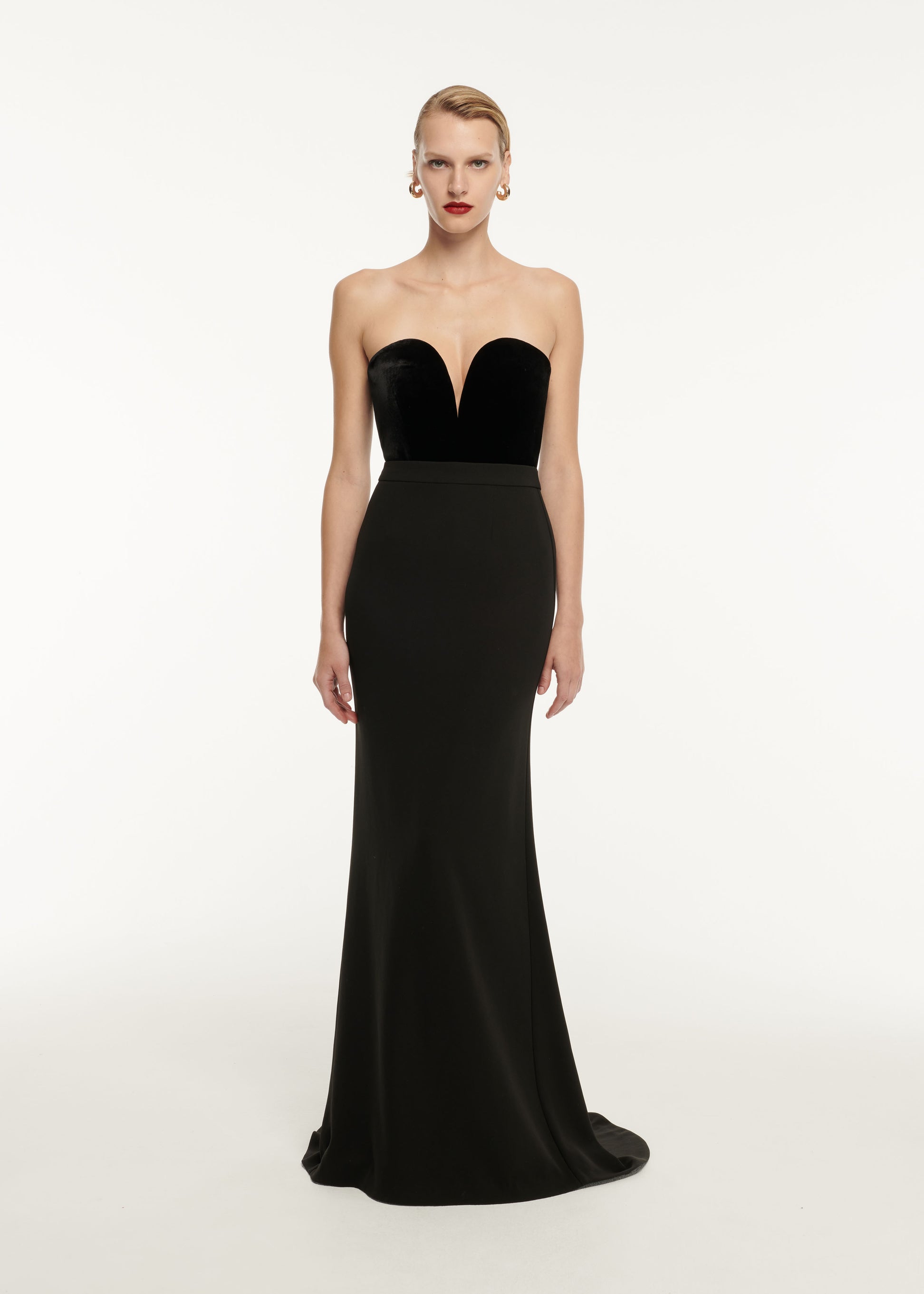 A woman wearing the Strapless Velvet Top in Black