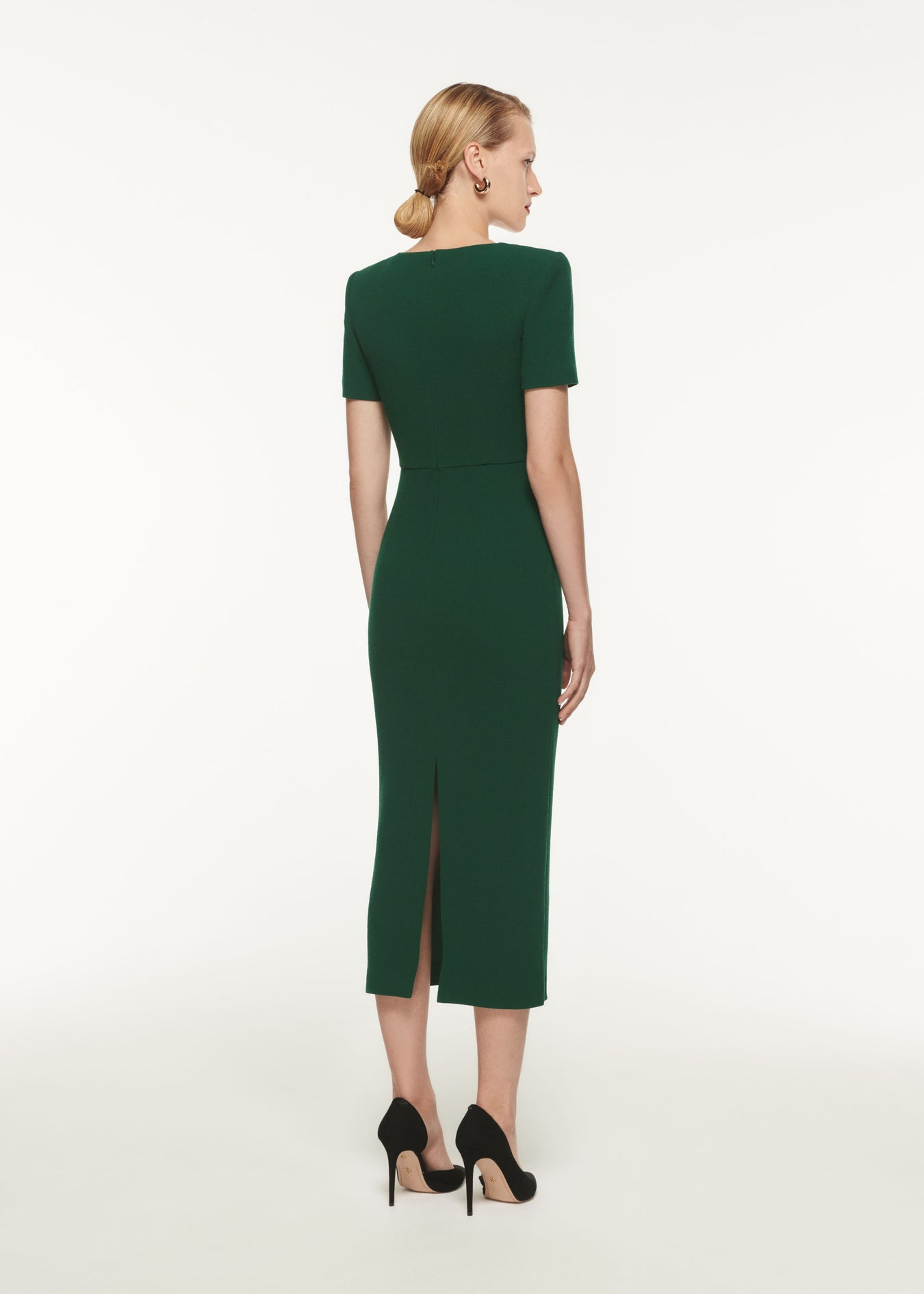 The back of a woman wearing the Short Sleeve Wool Crepe Midi Dress Green