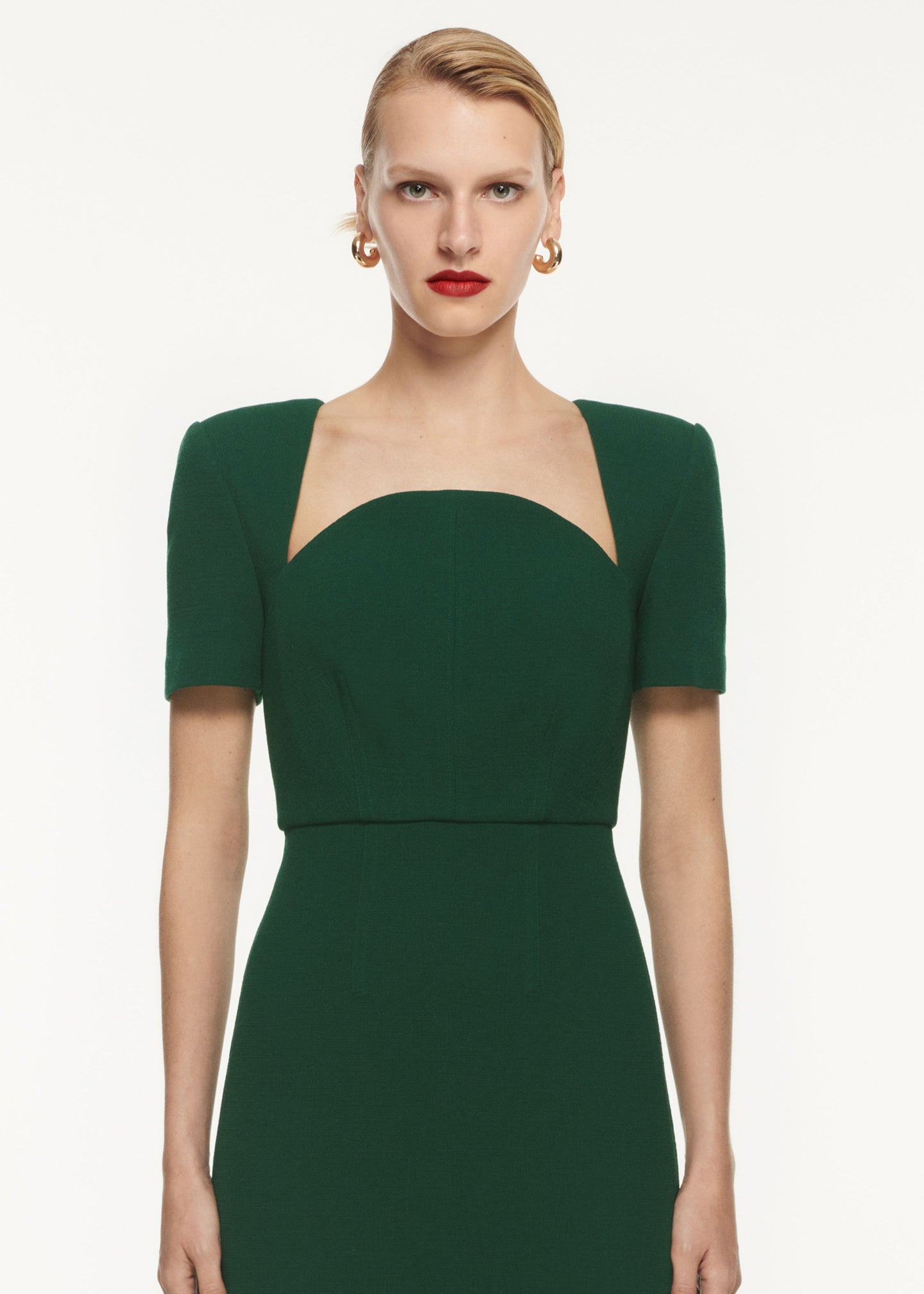 A close up of a woman wearing the Short Sleeve Wool Crepe Midi Dress Green
