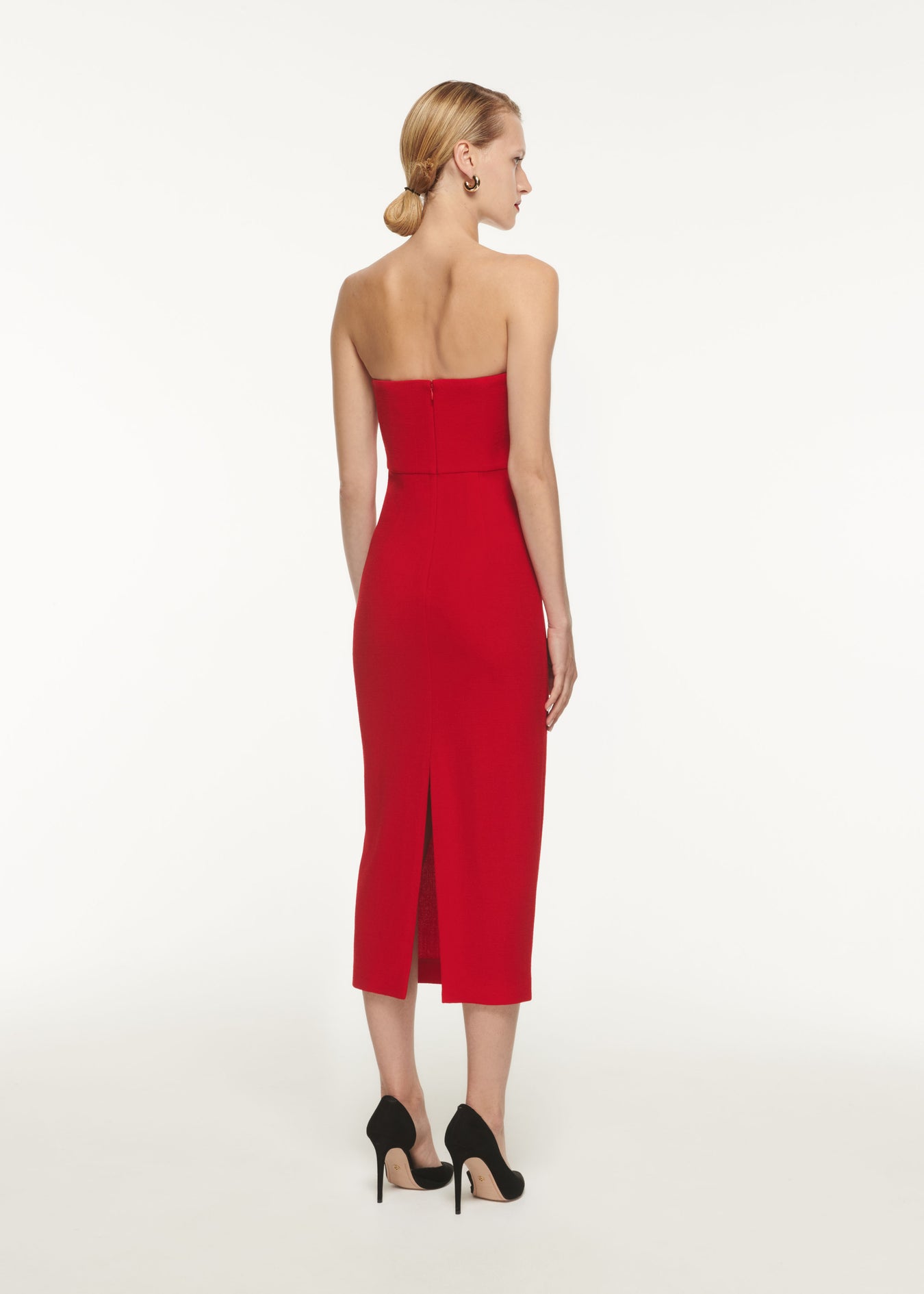 The back of a woman wearing the Asymmetric Wool Crepe Midi Dress