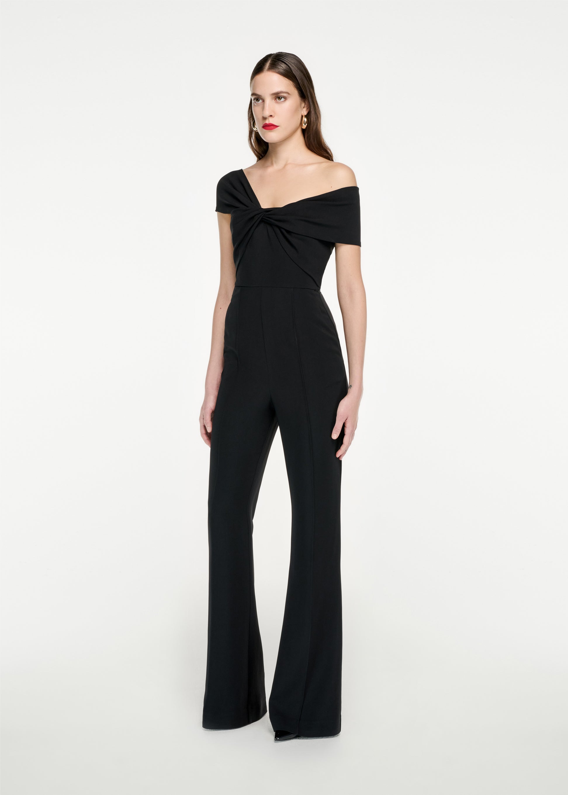 Woman wearing the Asymmetric Stretch Cady Jumpsuit in Black