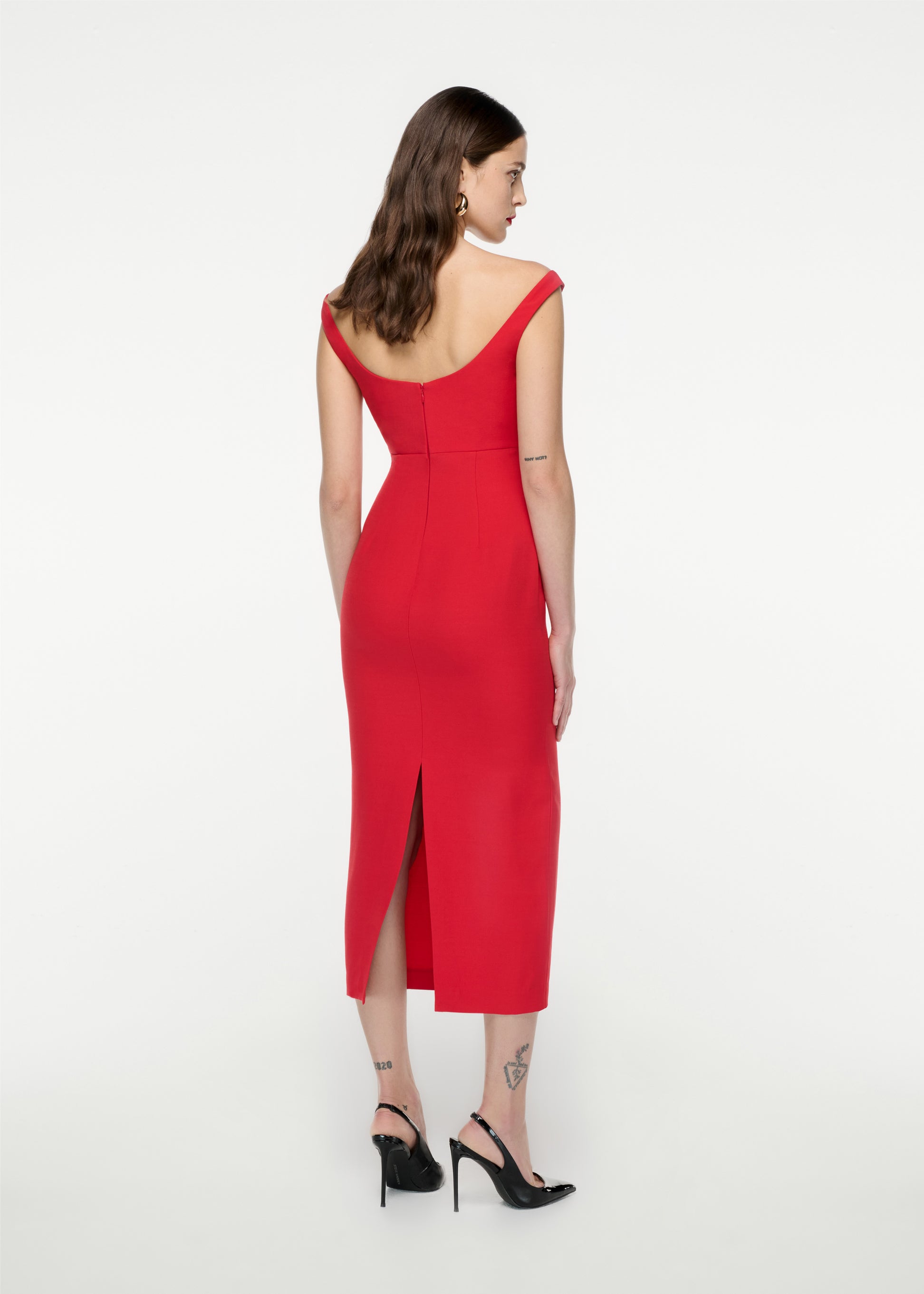 The back of a woman wearing the Off Shoulder Silk Wool Diamante Midi Dress in Red
