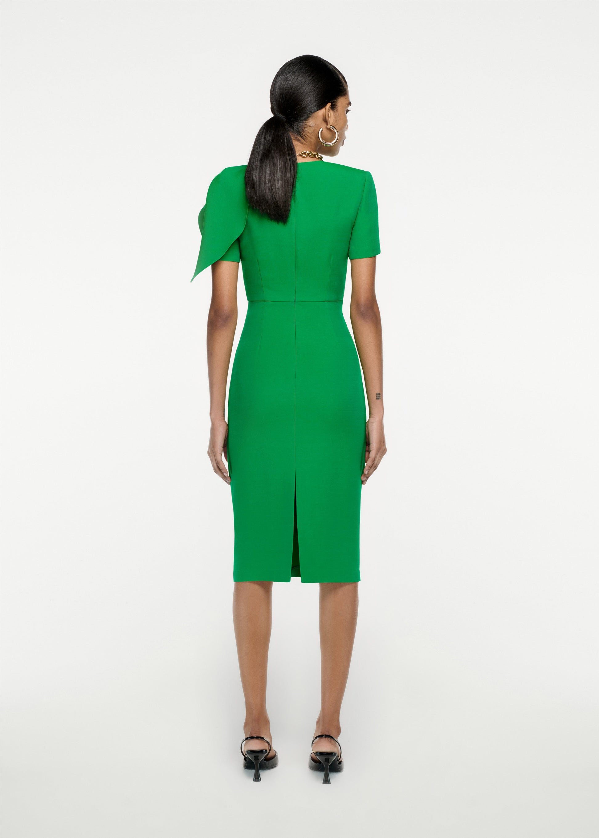 The back of a woman wearing the Short Sleeve Silk Wool knot Midi Dress in Green