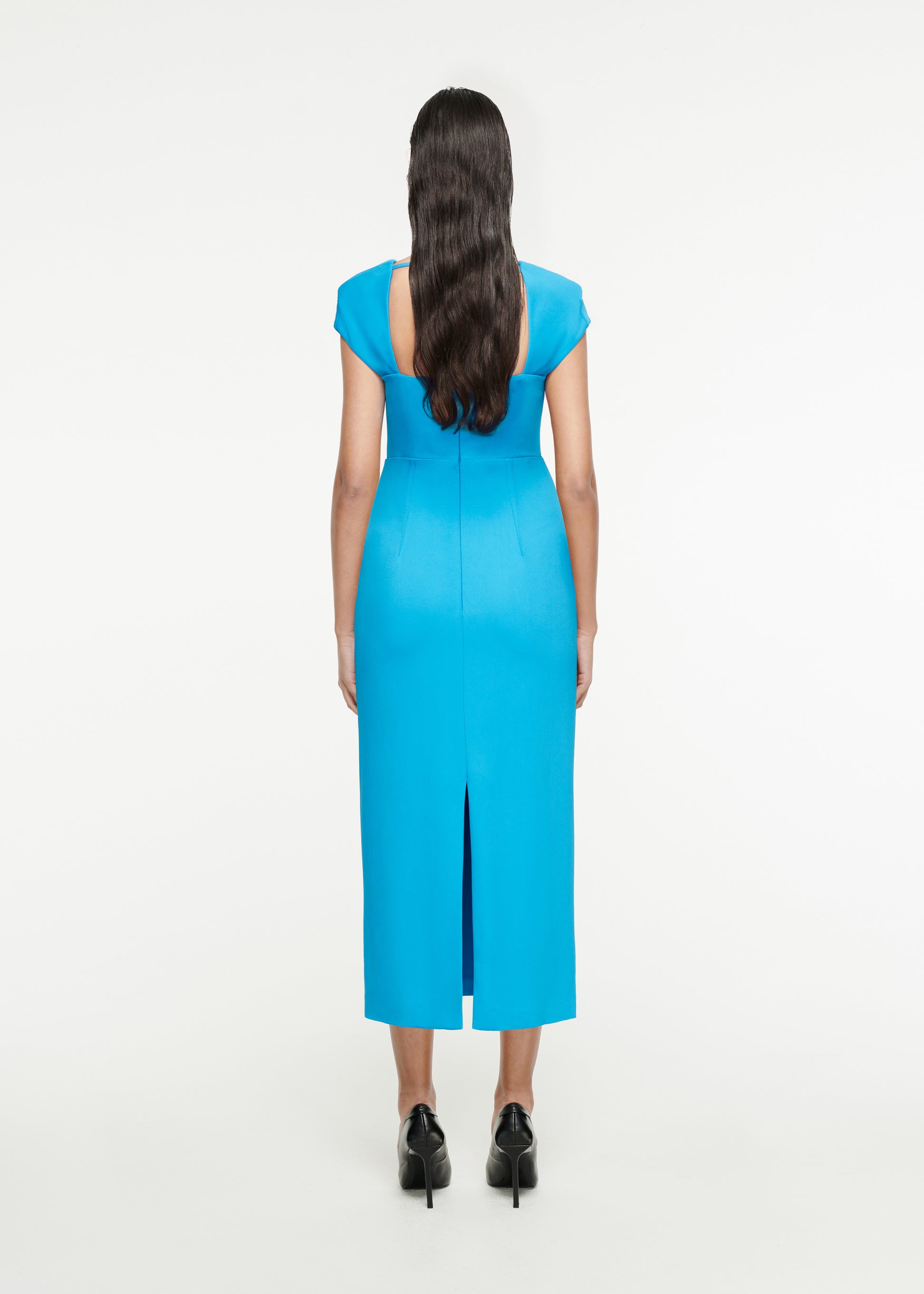 The back of a woman wearing the Cap Sleeve Stretch-Cady Midi Dress in Blue