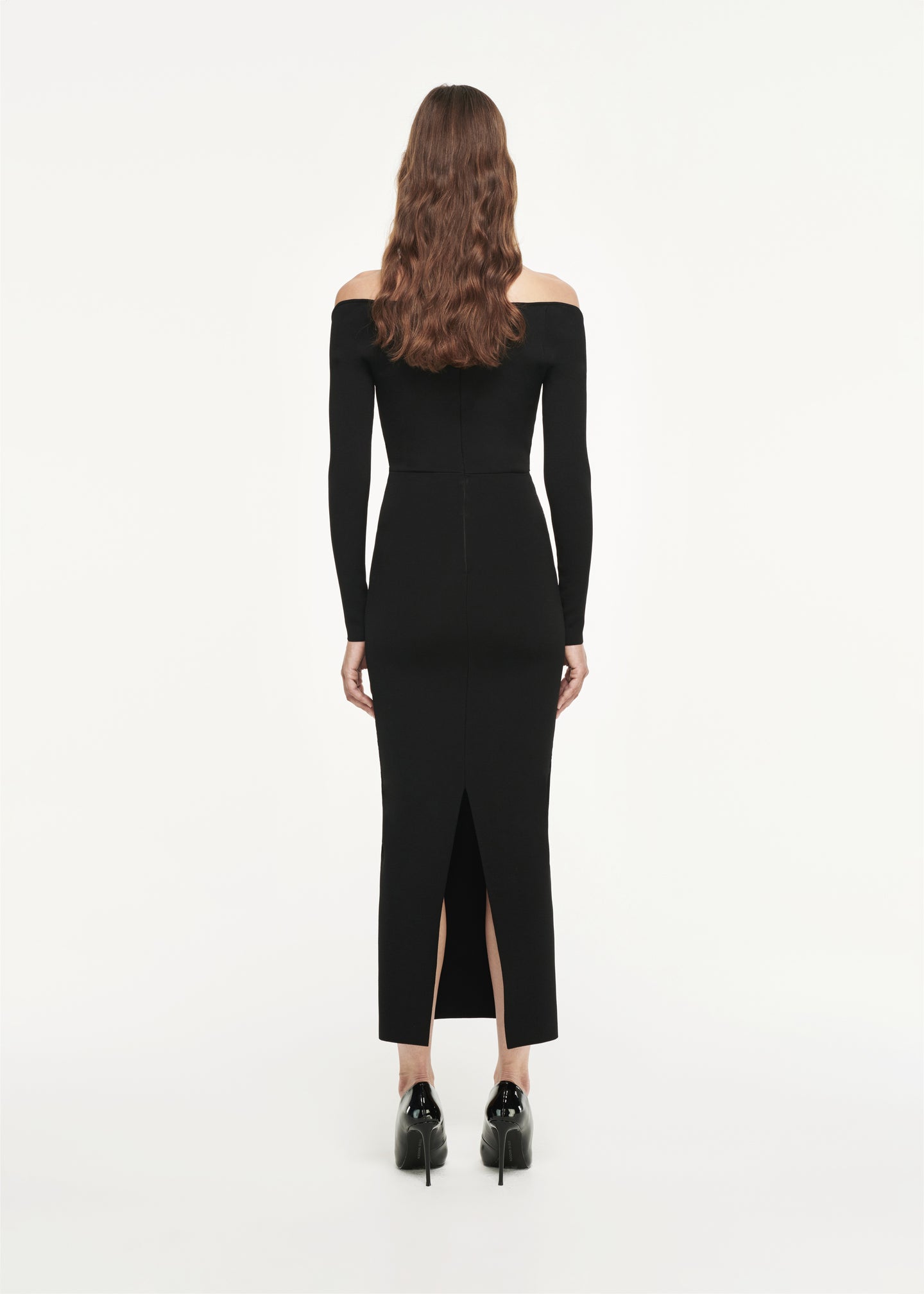 The back of a woman wearing the Long Sleeve Knit Midi Dress in Black