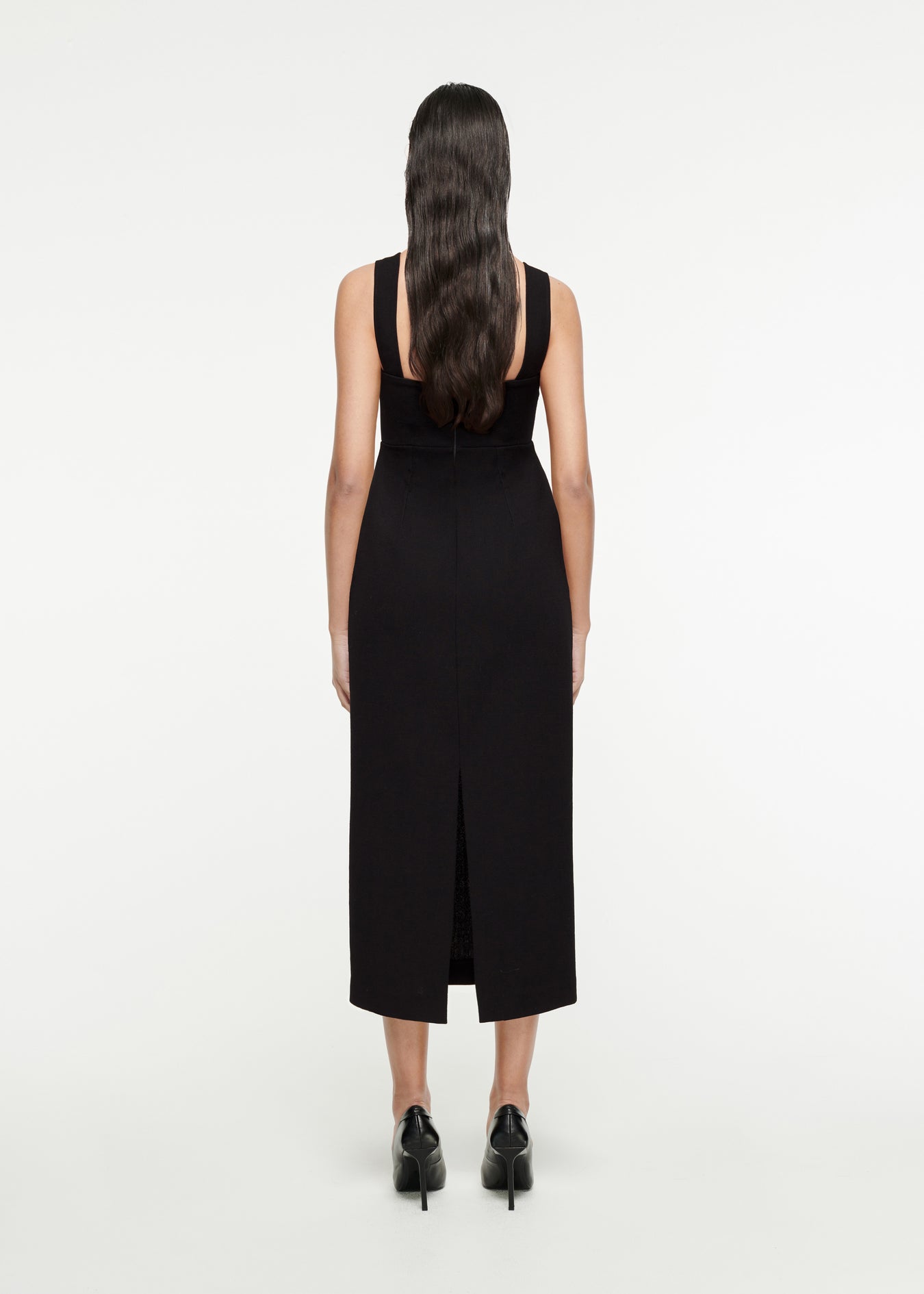 The back of a woman wearing the Wool Crepe Midi Dress in Black
