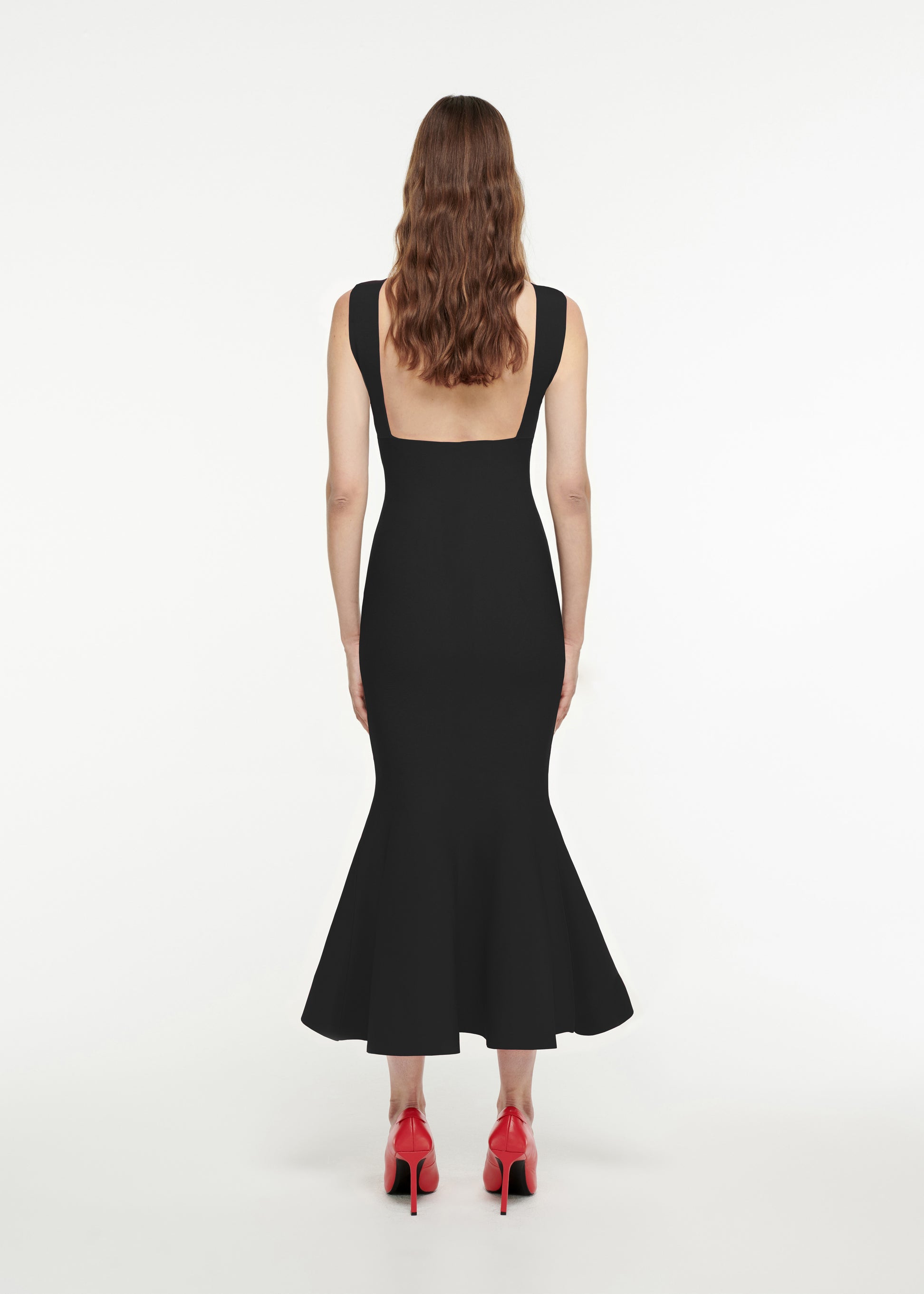 The back of a woman wearing the Knit Midi Dress in Black