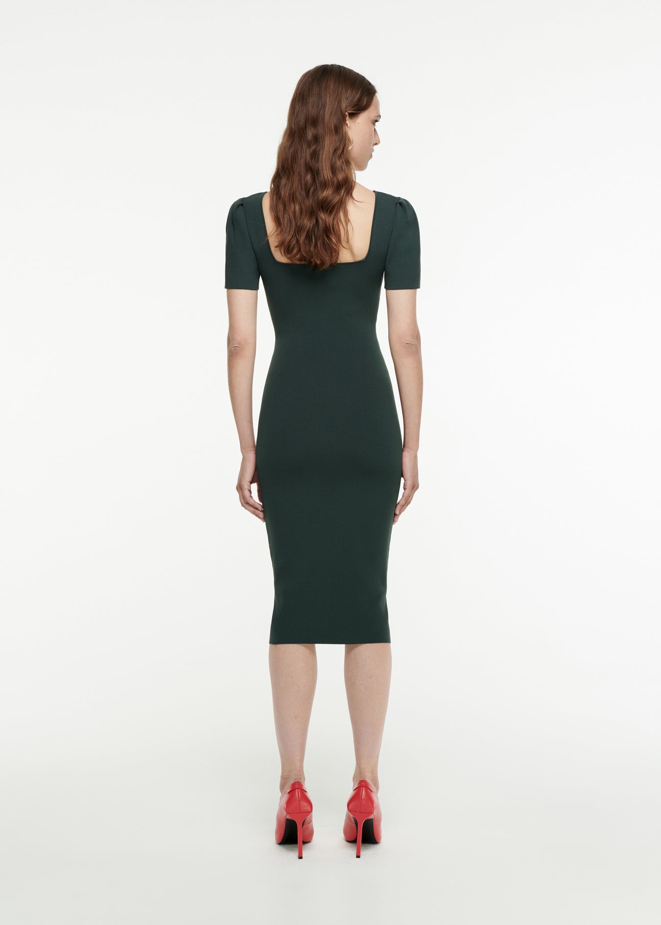 The back of a woman wearing the Short Sleeve Knit Midi Dress in Dark Green