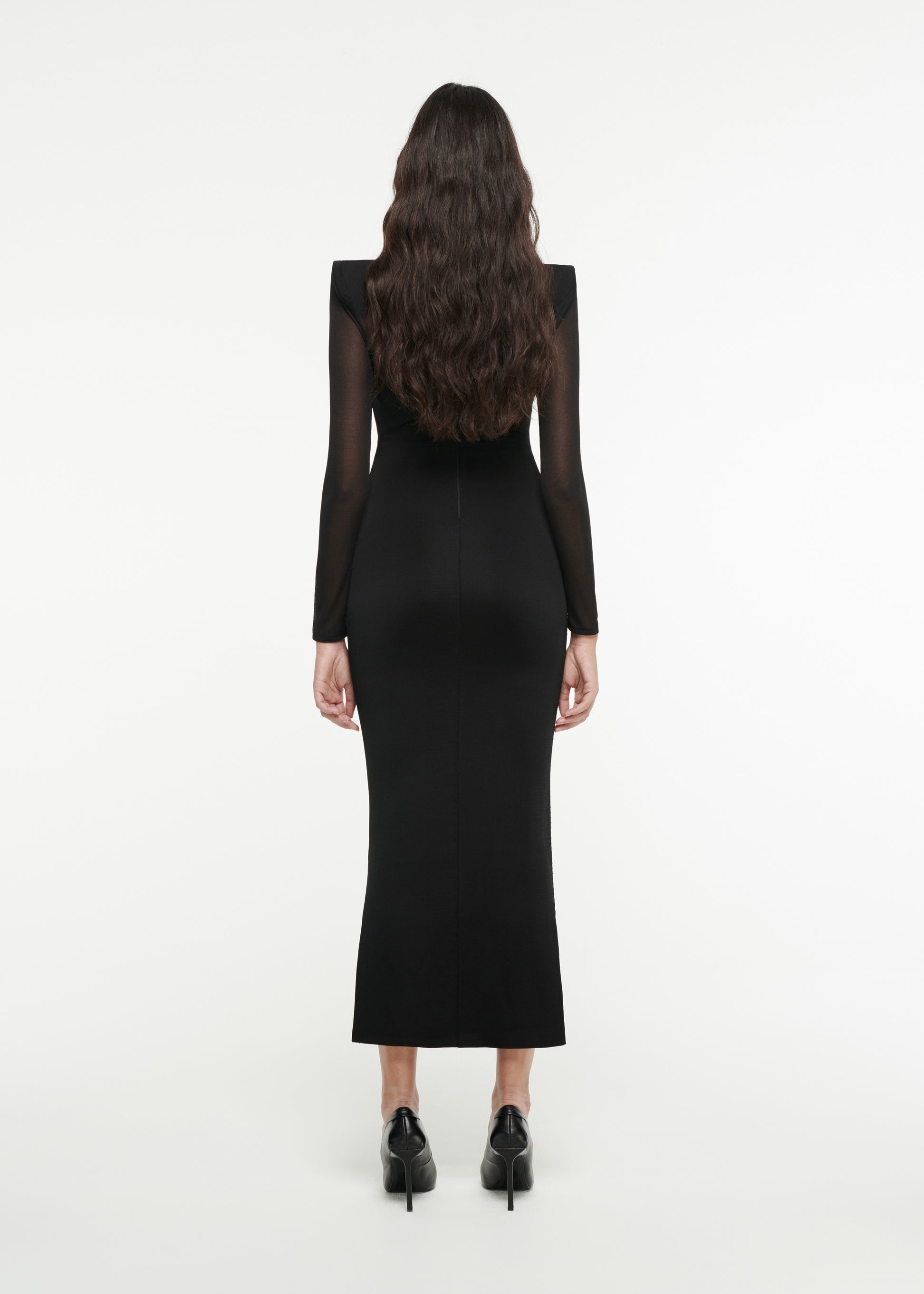 The back of a woman wearing the Long Sleeve Sheer Knit Midi in Black 