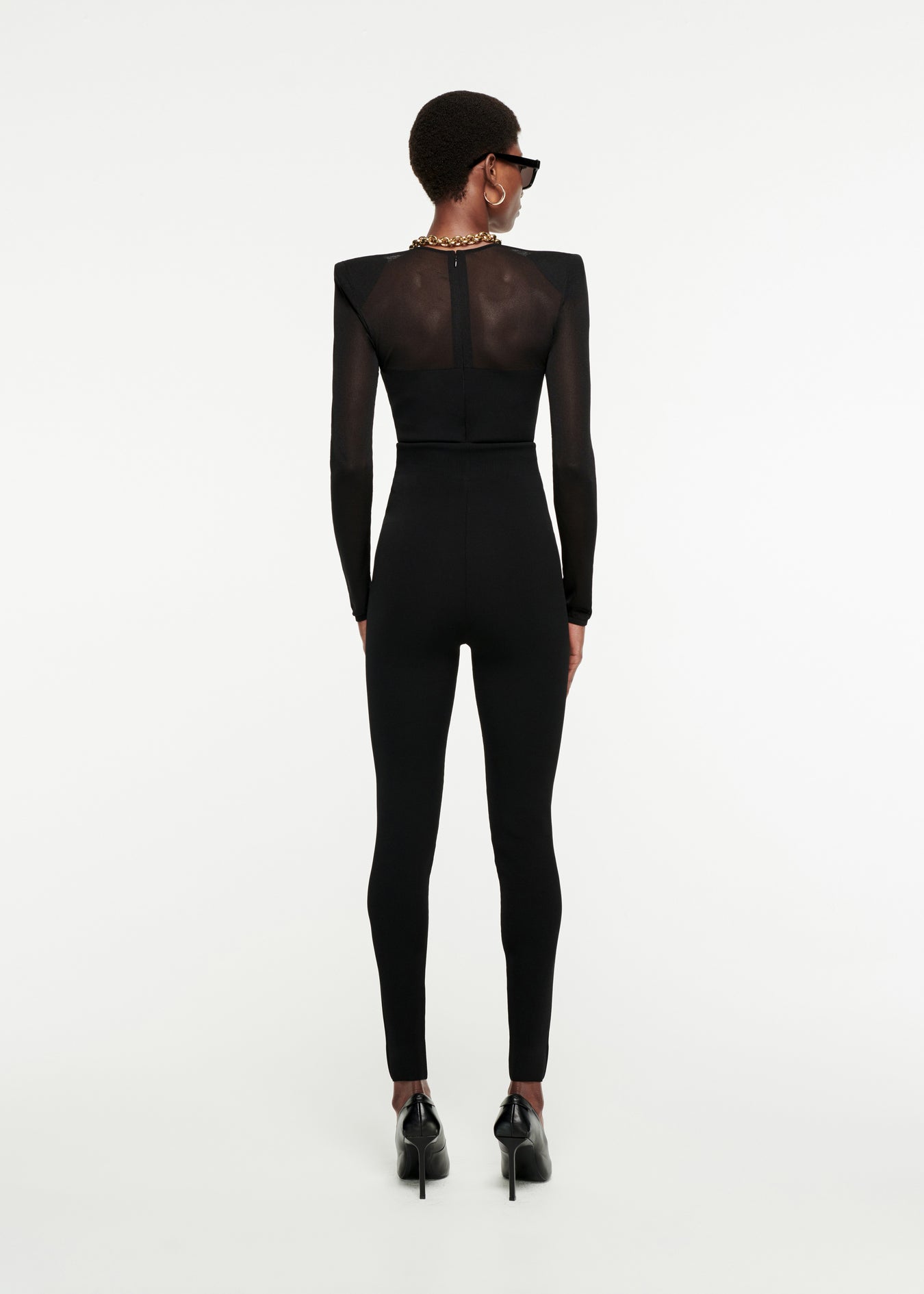 The back of a woman wearing the Long Sleeve Sheer Top in Black 