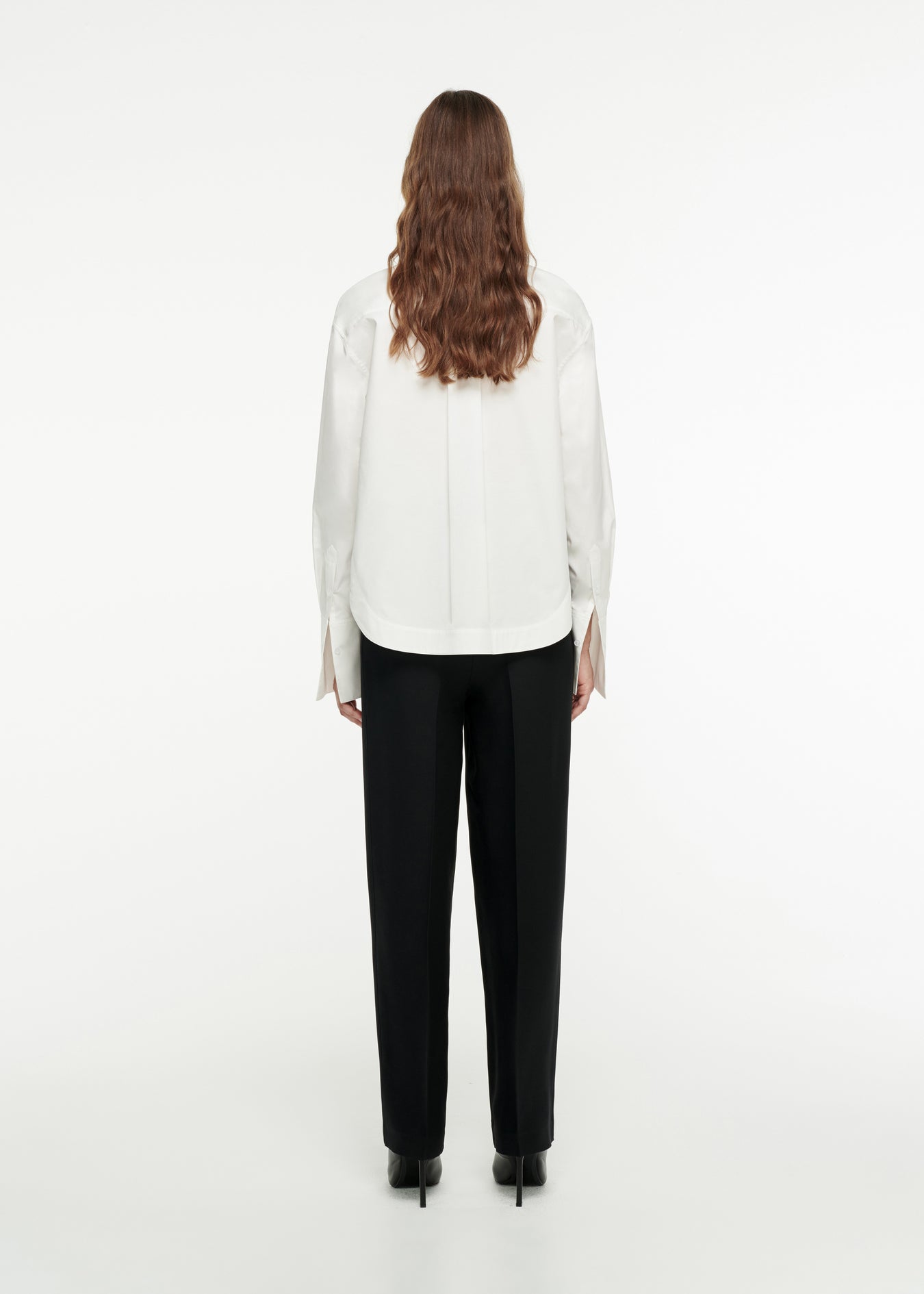 The back of a woman wearing the Oversized Organic Cotton Shirt in White 