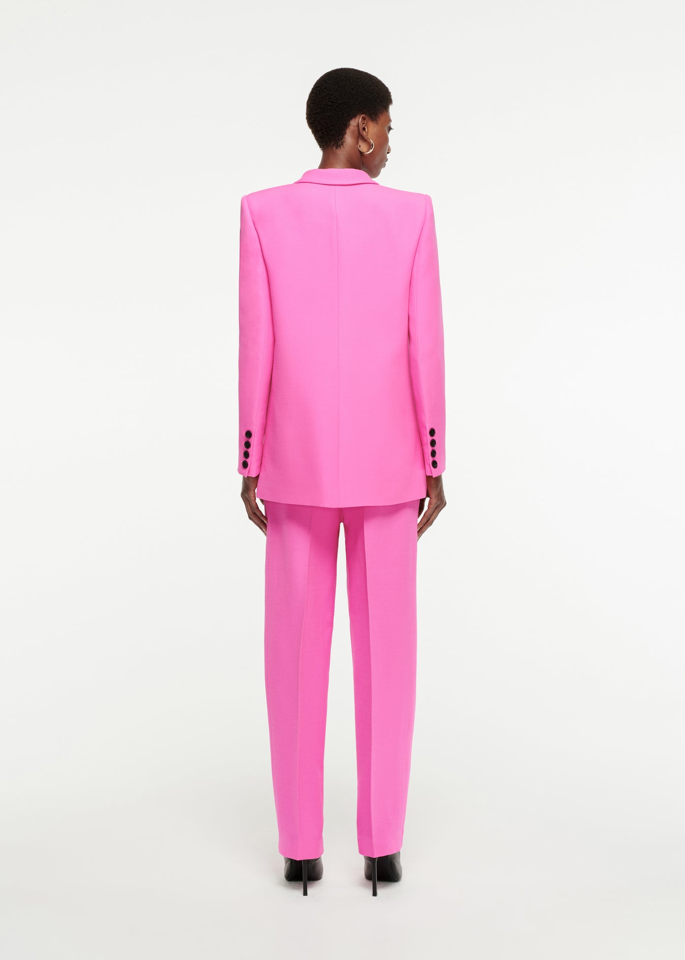 The back of a woman wearing the Straight-Cut Silk Wool Trouser in Pink 