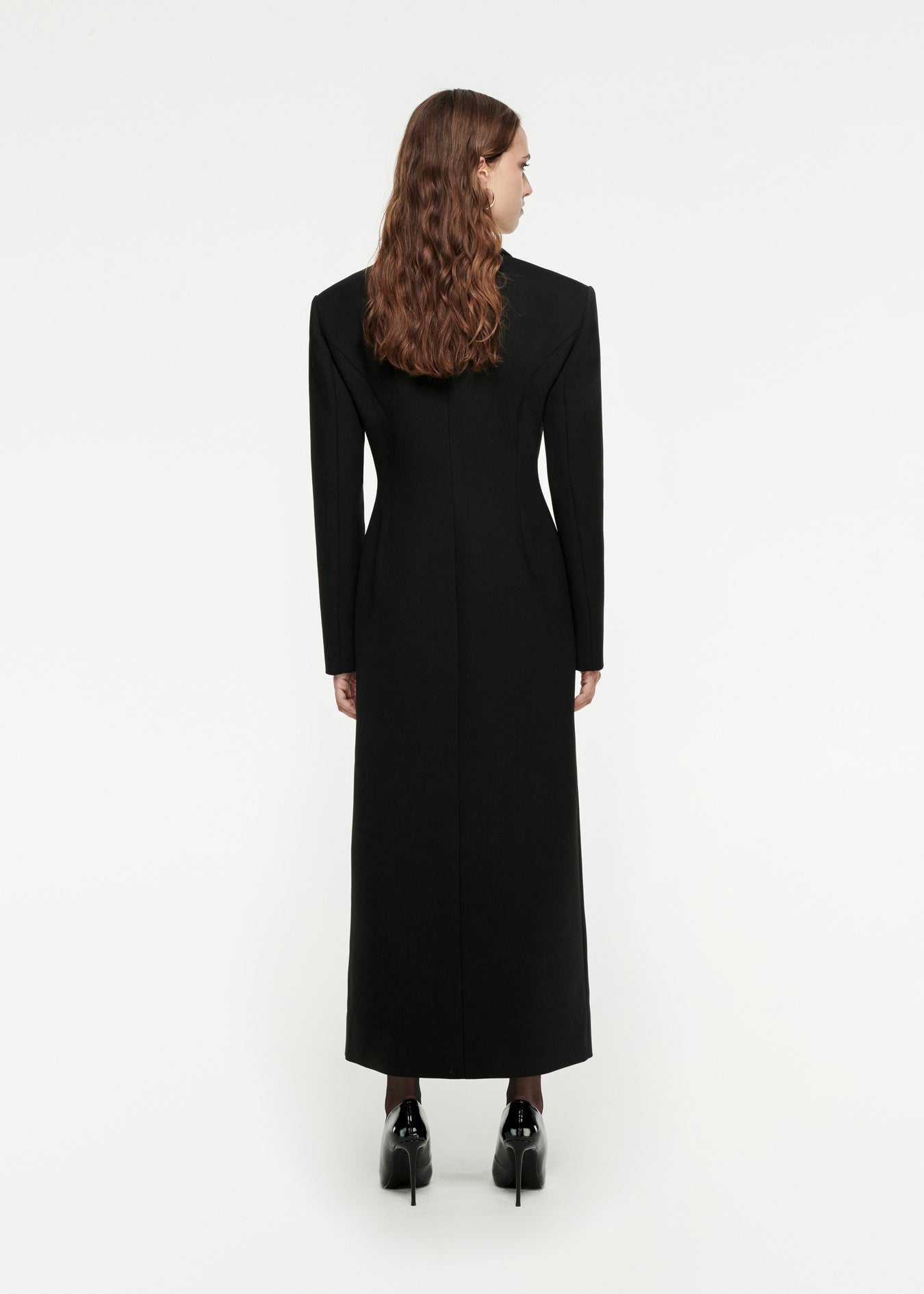 The back of a woman wearing the Double-Breasted Wool Coat in Black