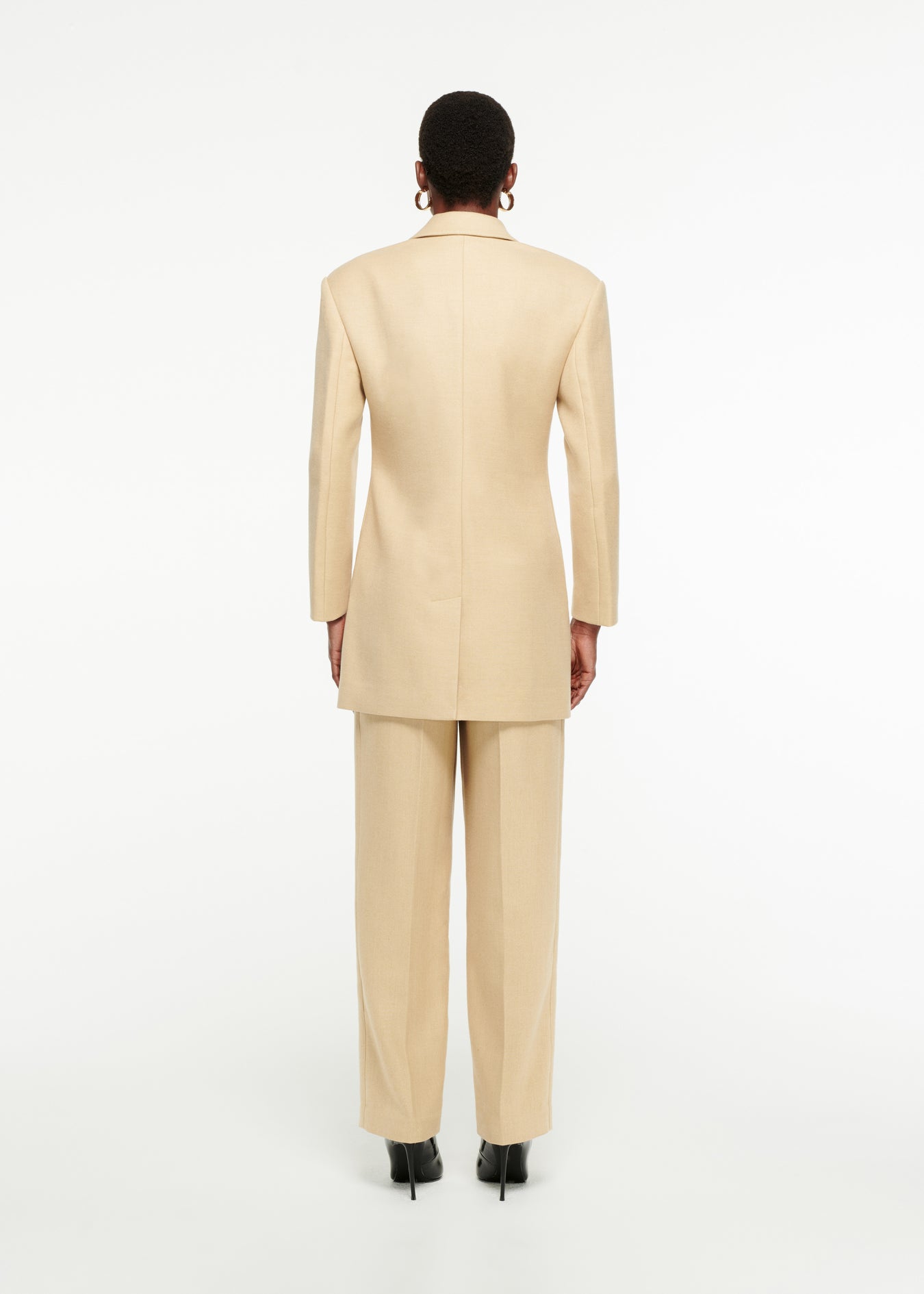 The back of a woman wearing the Oversized Double-Breasted Wool Blazer in Sand