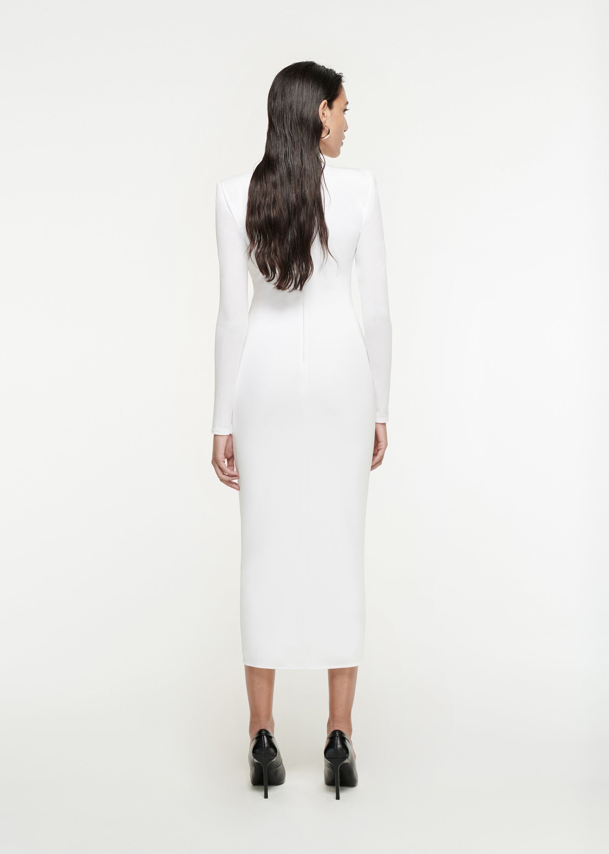 The back of a woman wearing the Long Sleeve Jersey Midi Dress in White