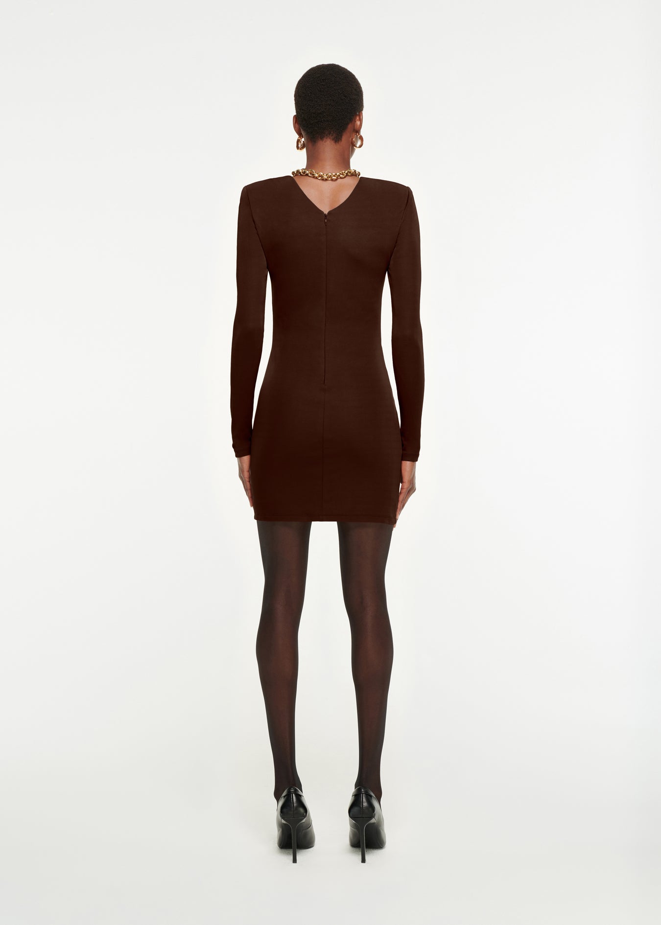 The back of a woman wearing the Long Sleeve Jersey Mini Dress in Brown