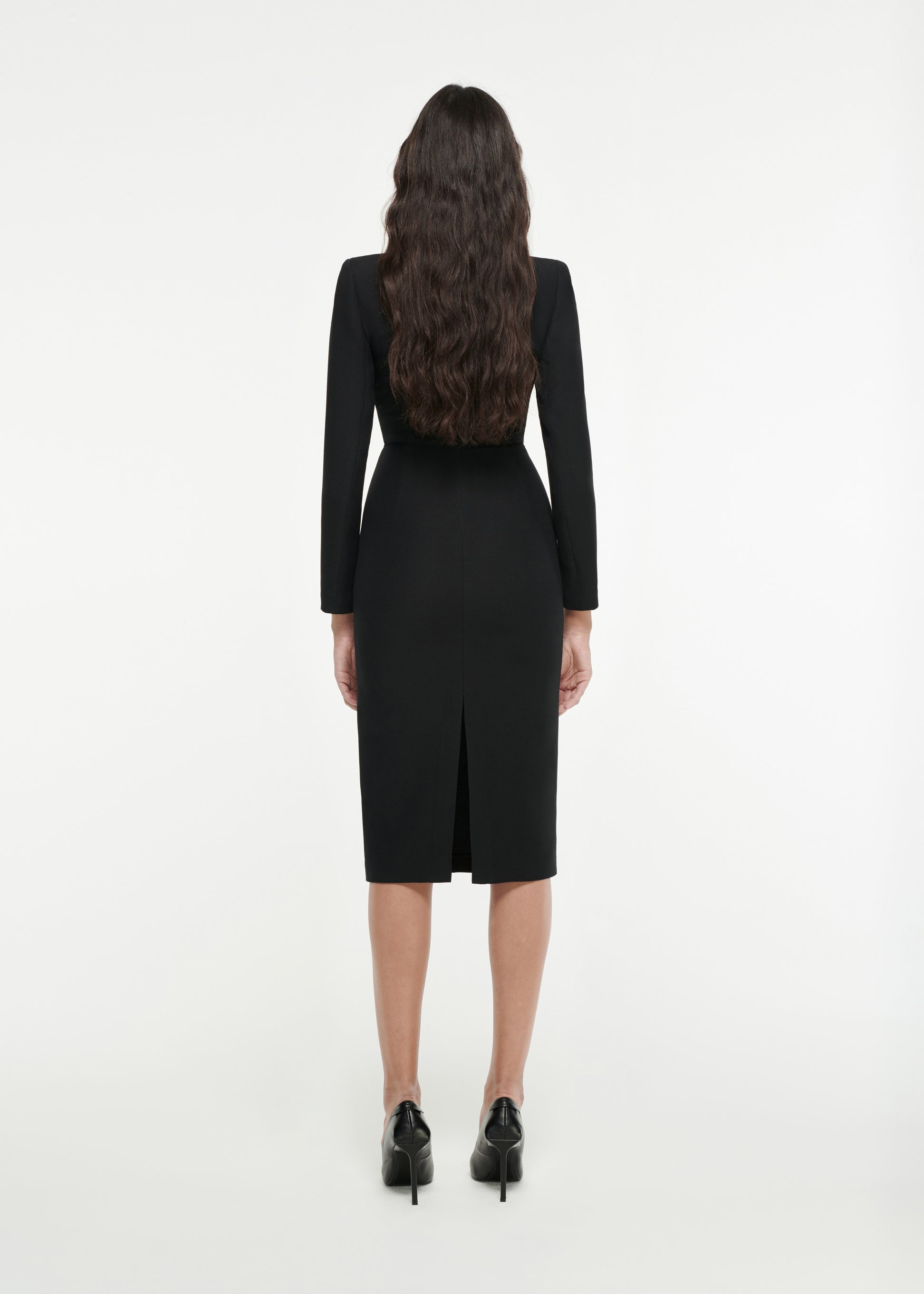 The back of a woman wearing the Long Sleeve Silk Wool Midi Dress in Black