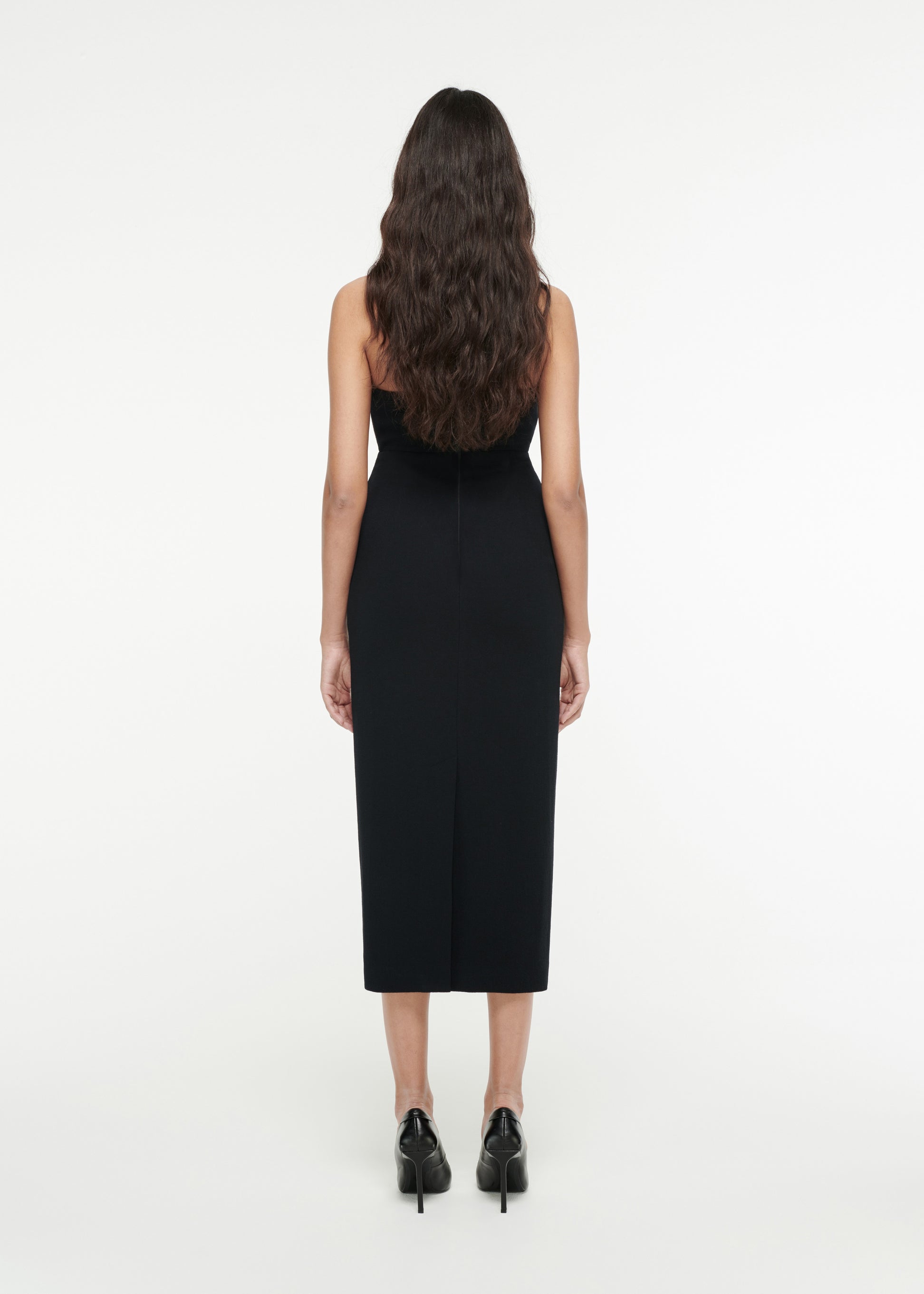 The back of a woman wearing the Strapless Moon Midi Dress in Black 