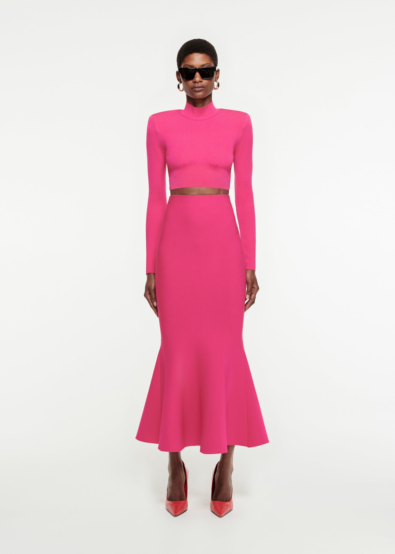 Woman wearing the Fluted Knit Midi Skirt in Pink