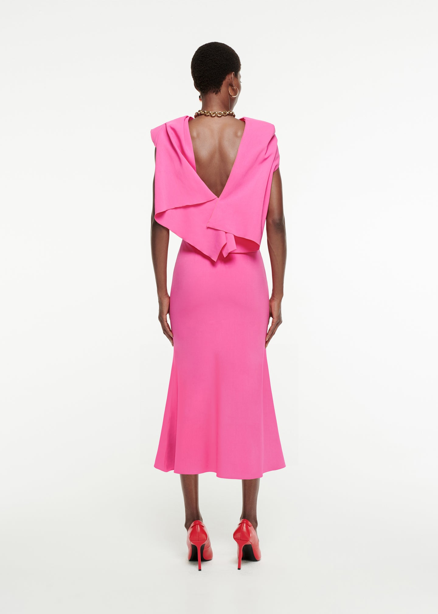 The back of a woman wearing the Draped Stretch-Cady Midi Dress in Pink