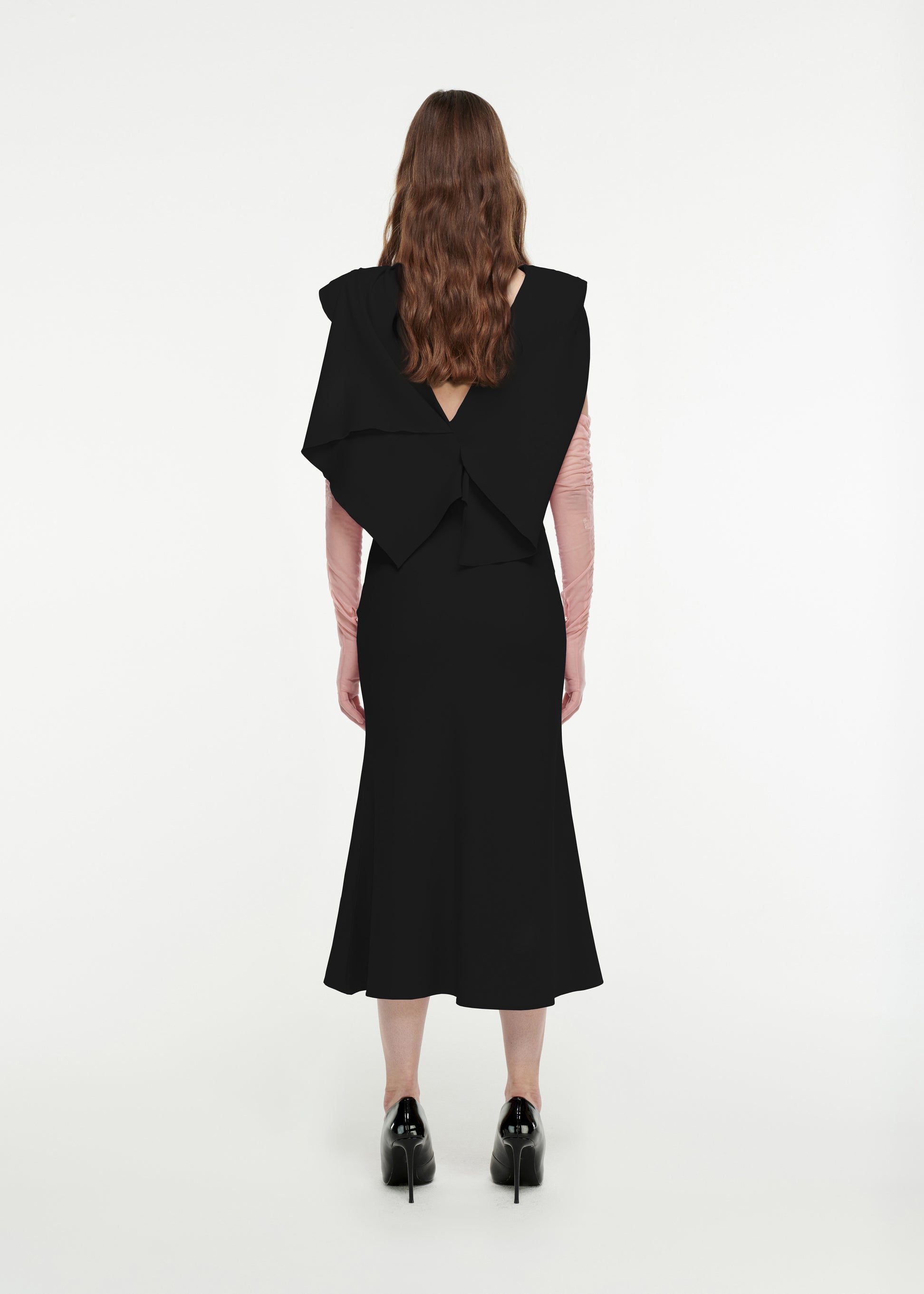 The back of a woman wearing the Draped Stretch-Cady Midi Dress in Black