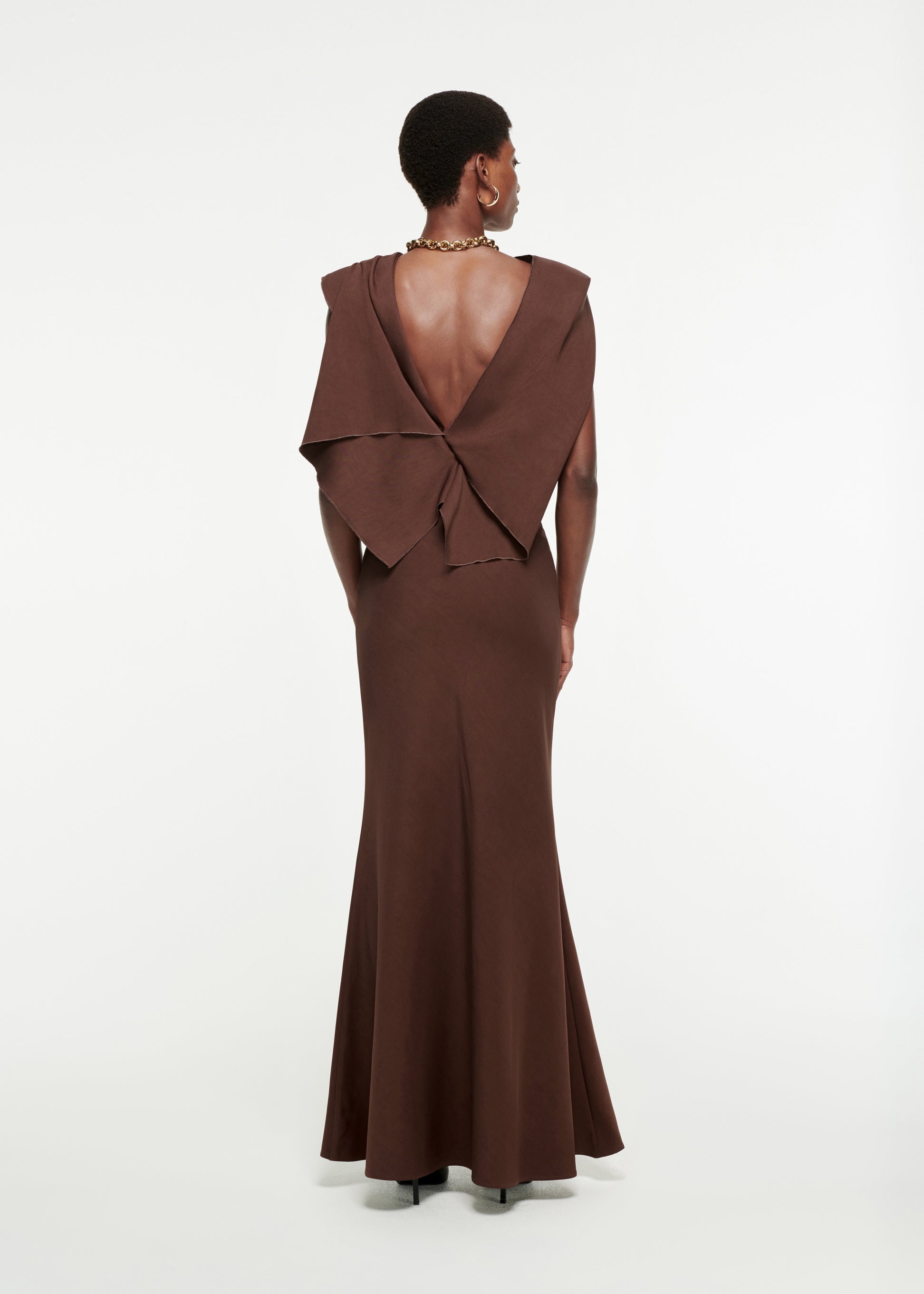 The back of a woman wearing the Draped Stretch-Cady Gown in Brown
